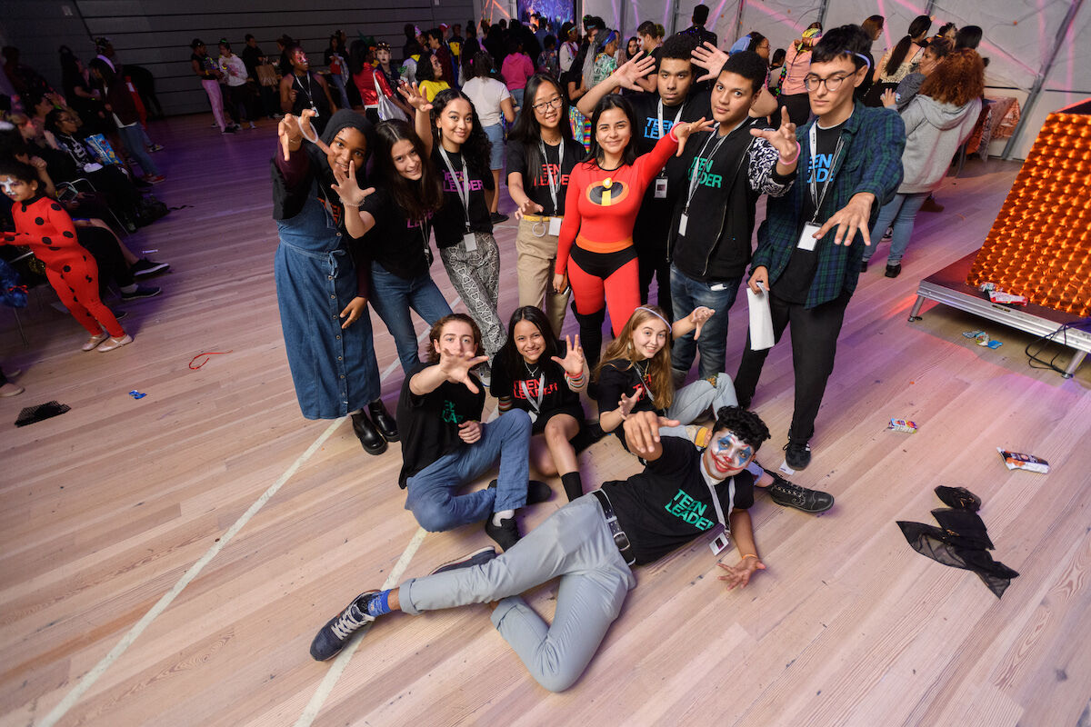 Teens dressed for Halloween gather for a picture. 