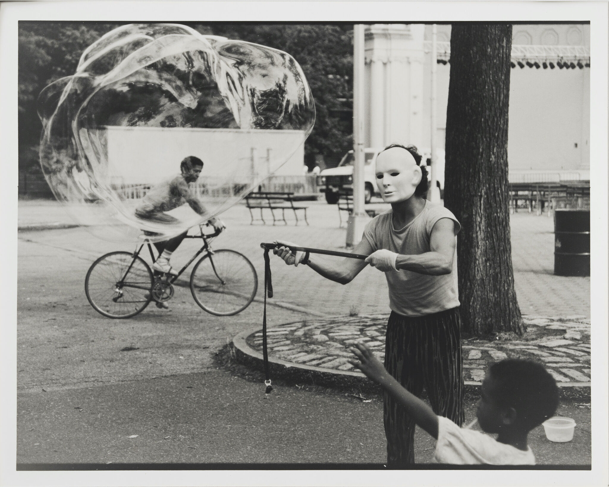 A man in a mask creating an enormous bubble.