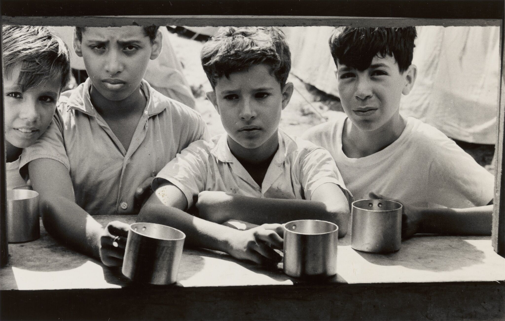 Four boys with empty cups.