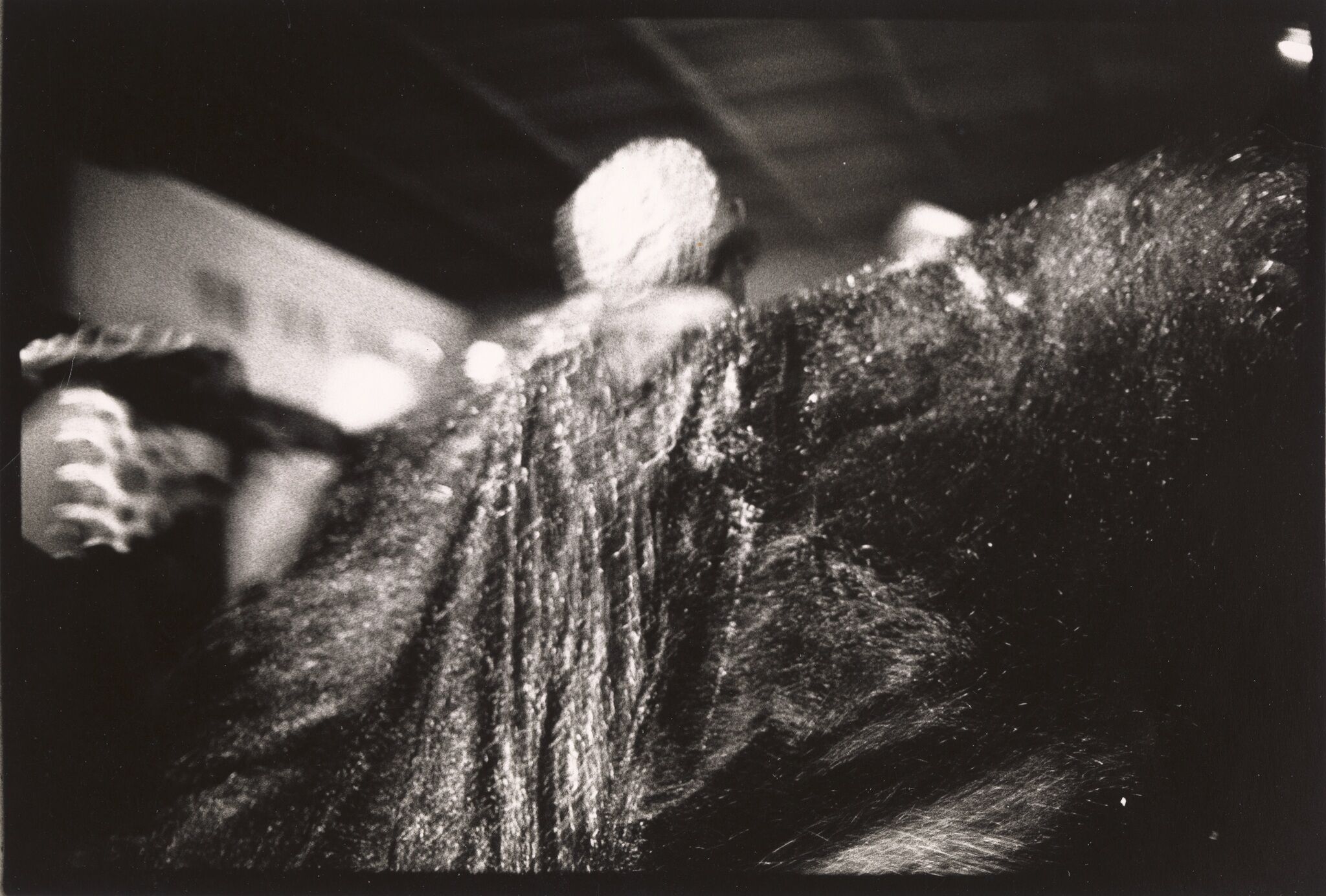 A figure with their back turned in a sparkly cape.