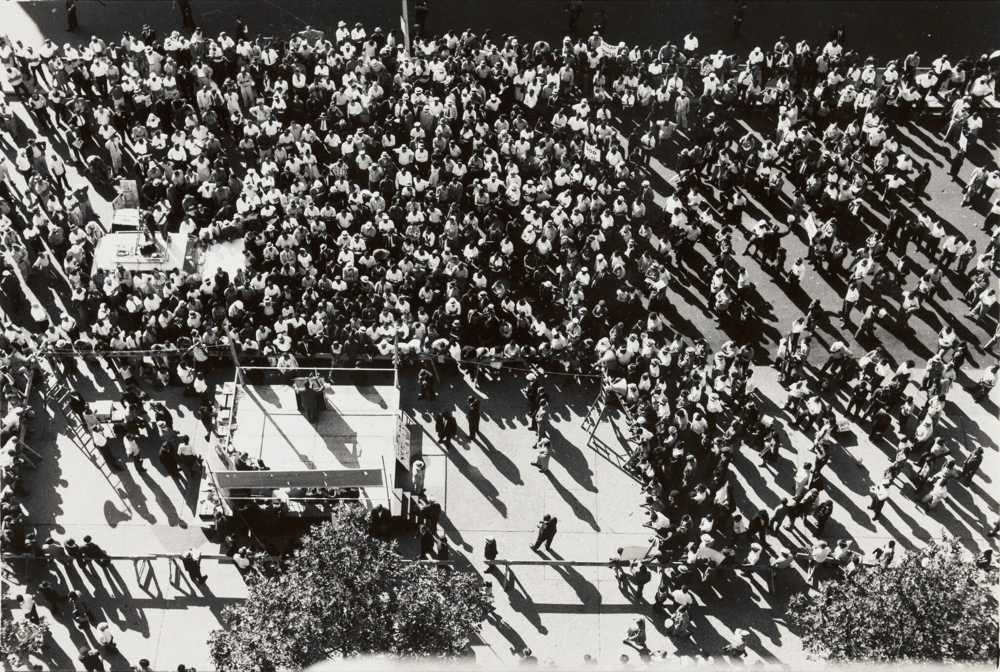 An aerial view of a crowd around a small stage.