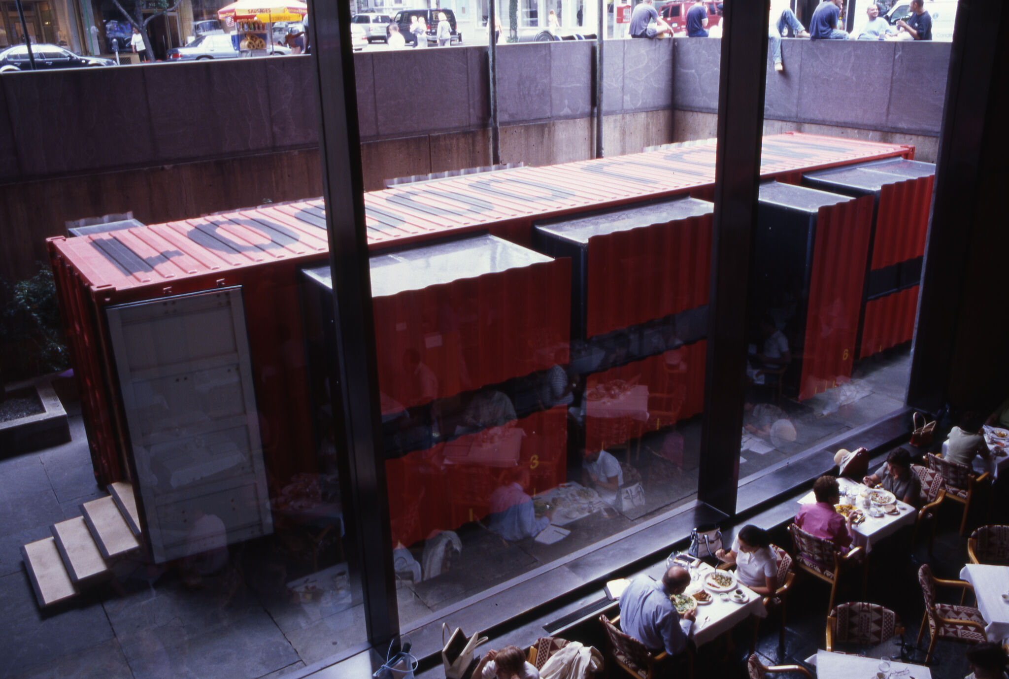 A horizontal view of LOT-EK: Mobile Dwelling Unit through a window.