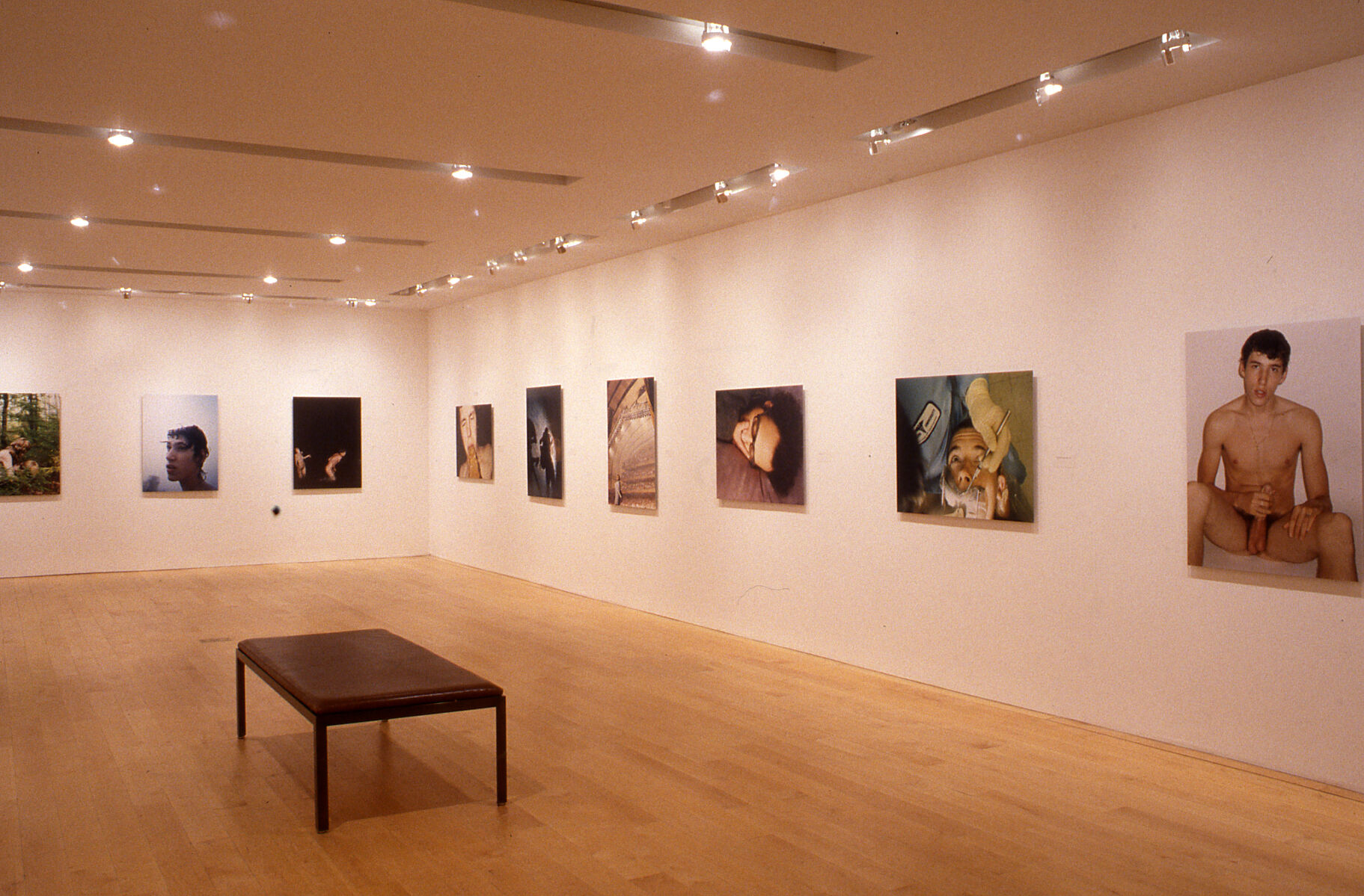 A gallery filled with photographs displayed on the walls.