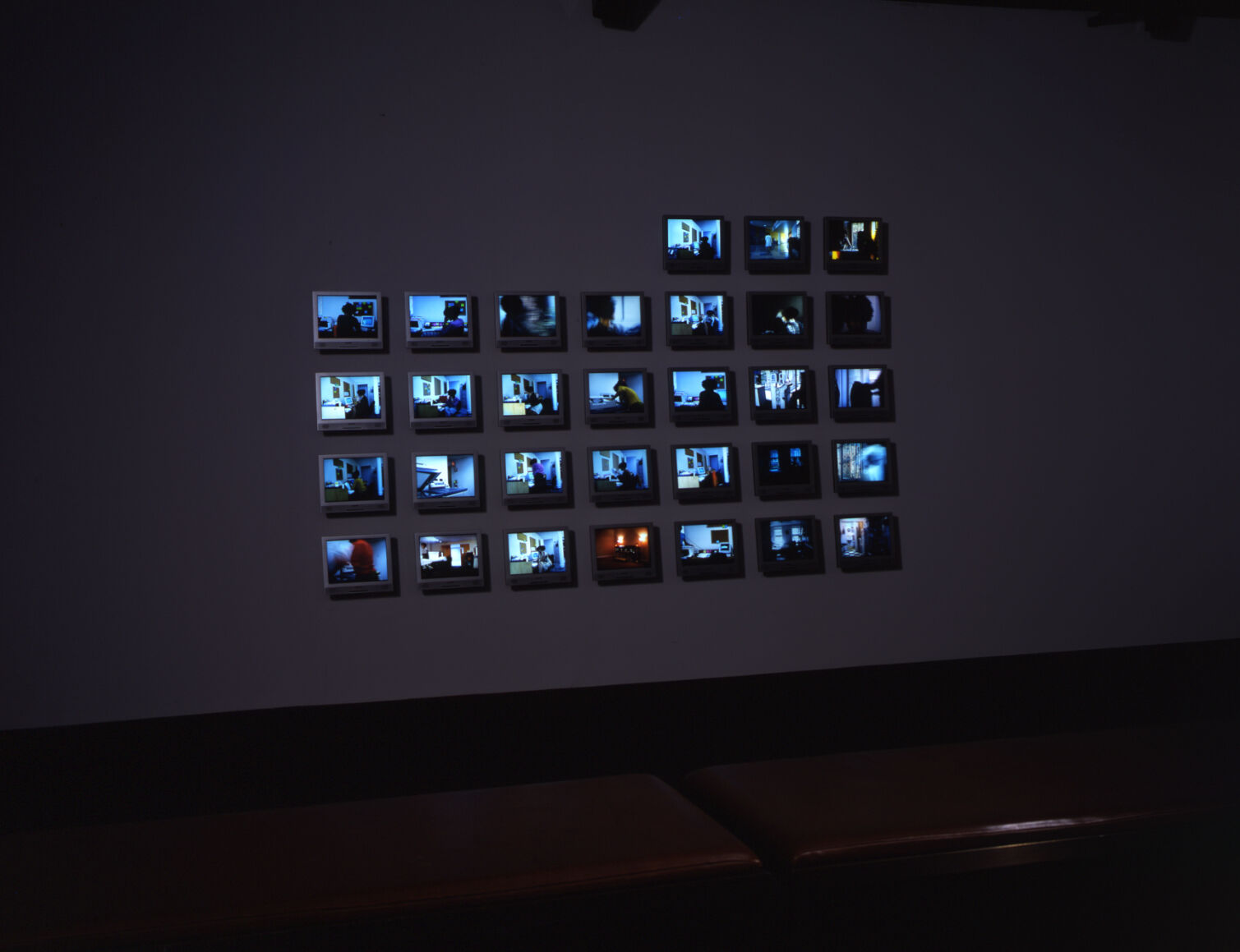 A group of small screens displaying images tinted blue.