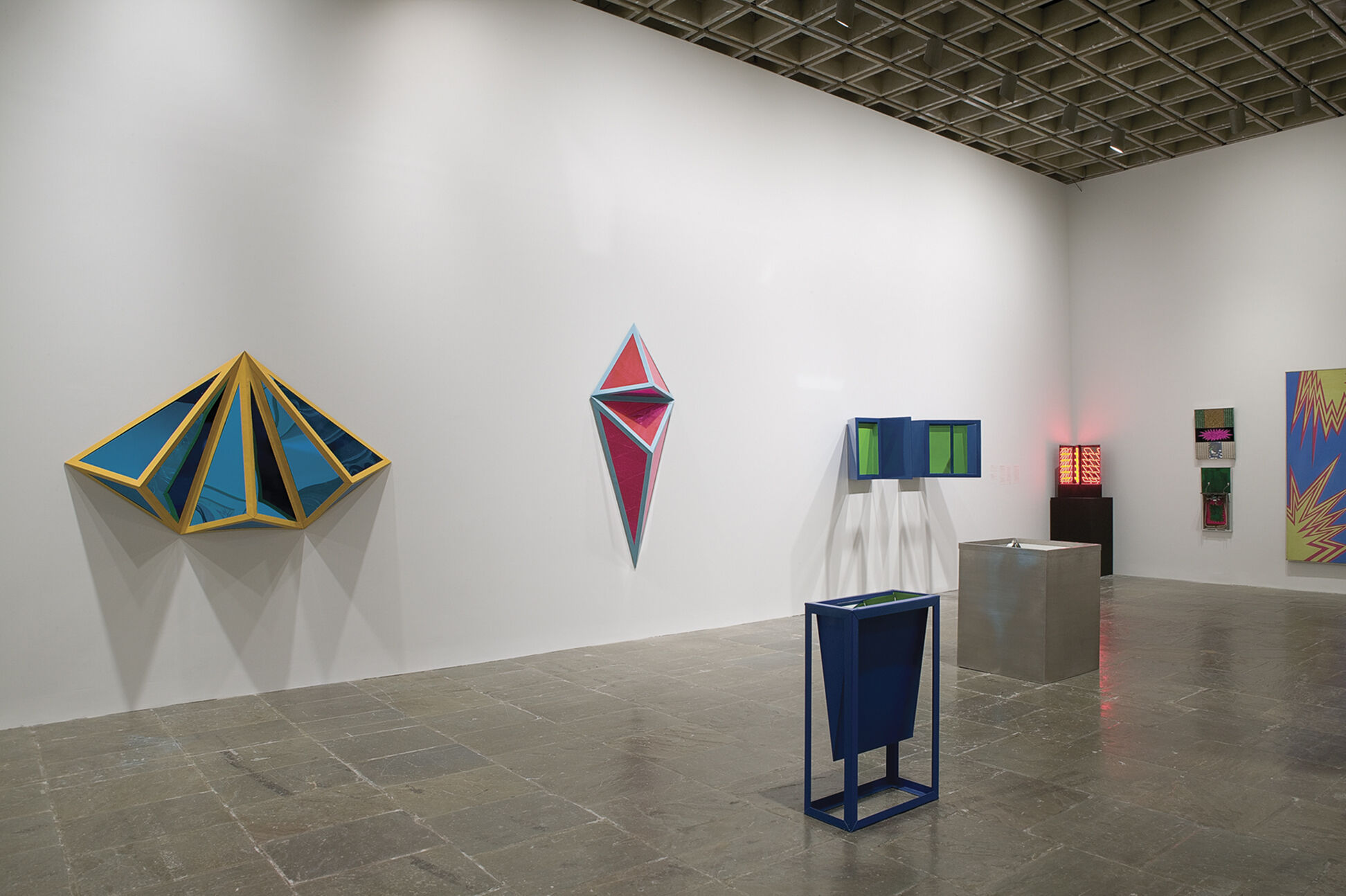 Colorful sculptures displayed in a gallery.