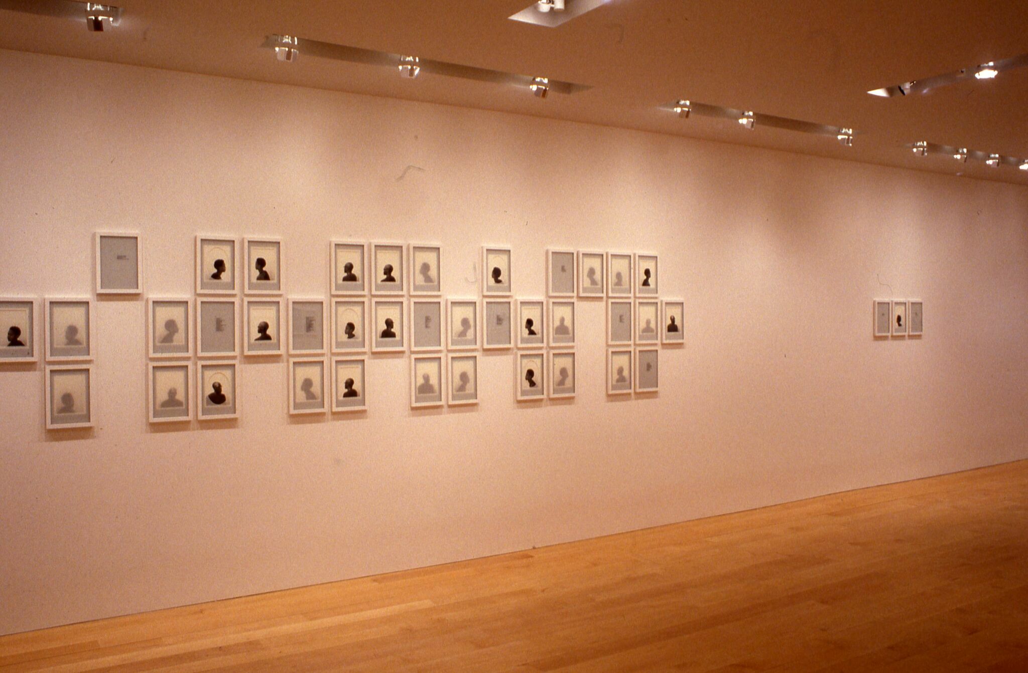 A series of frames in a gallery displaying artworks depicting silhouettes.