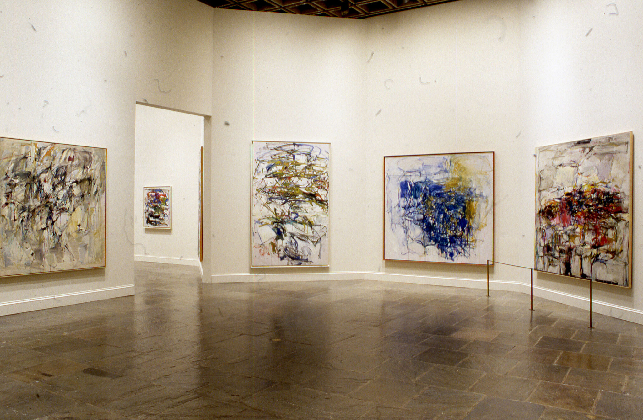 Abstract paintings displayed in a gallery.