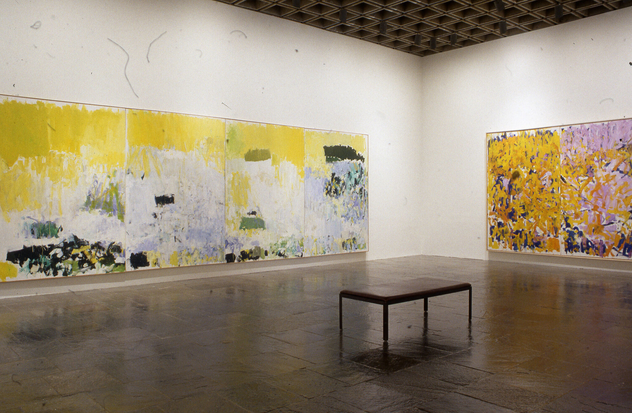 Large abstract paintings displayed in a gallery.