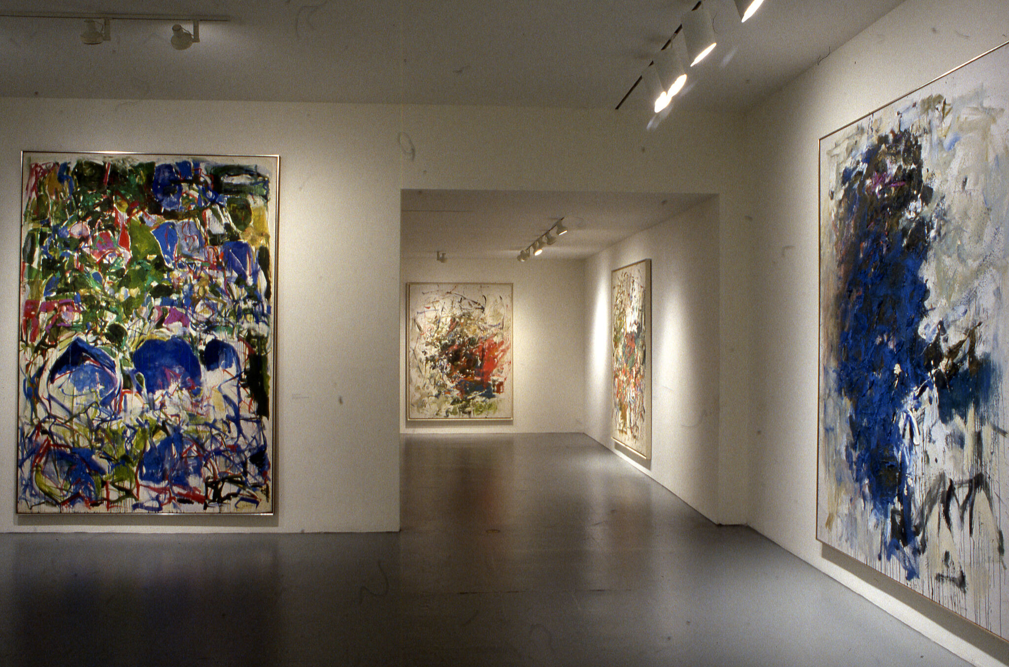 Abstract paintings displayed in a gallery.