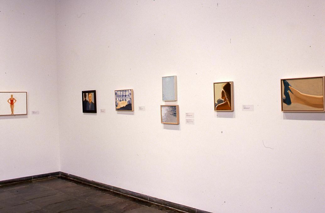 Small paintings displayed in a gallery.