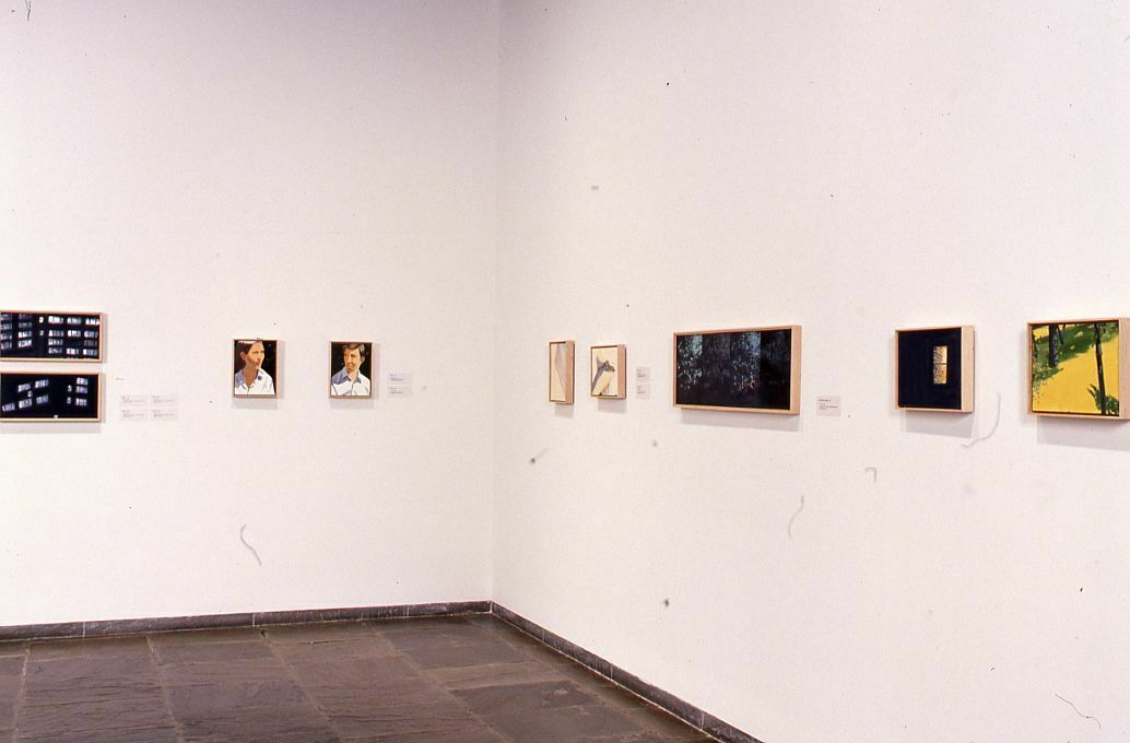 Small paintings displayed in a gallery.
