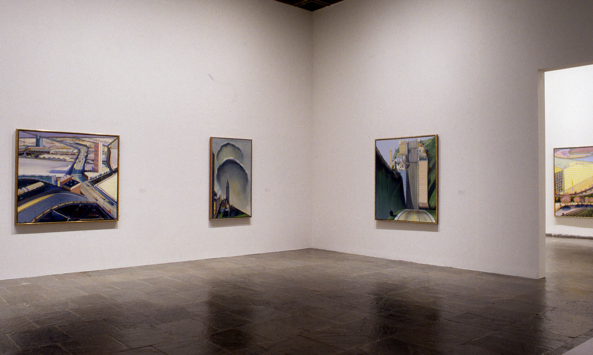 Paintings displayed in a gallery.