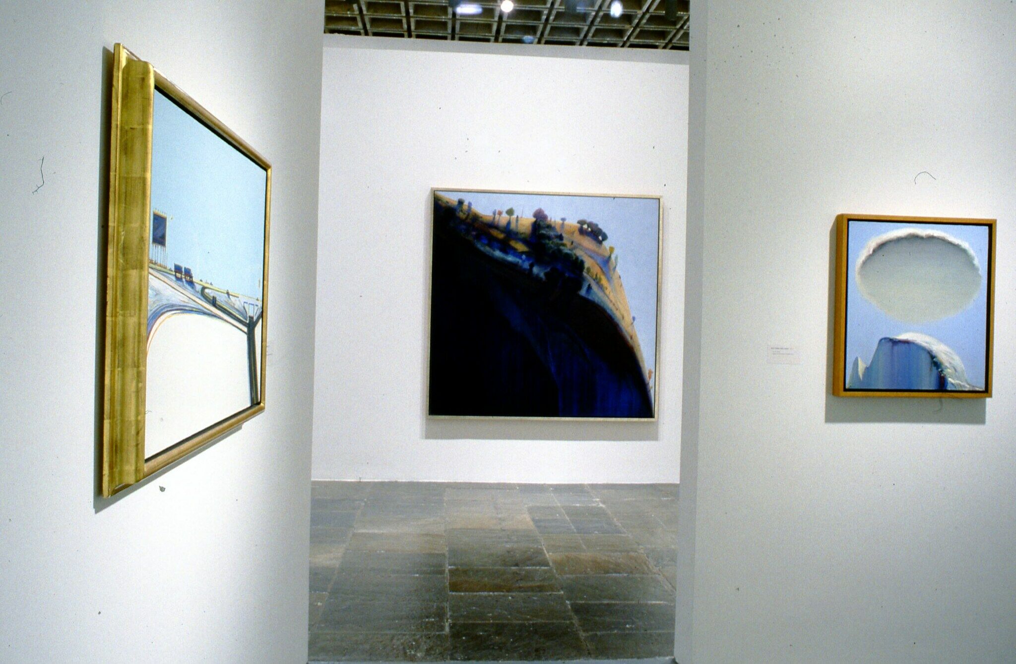 Paintings displayed in a gallery.