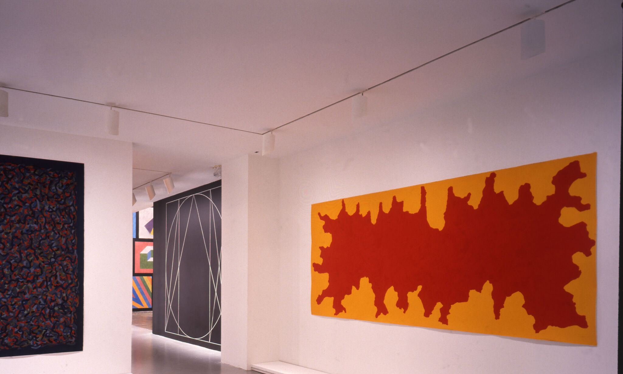 A gallery with abstract paintings.