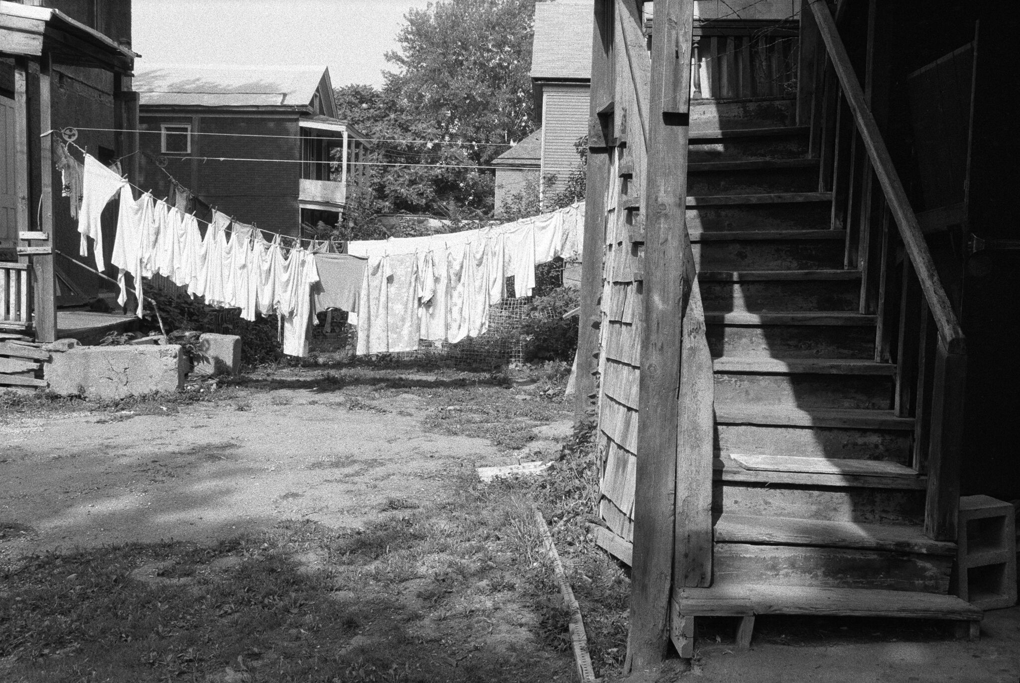 Clothes are left to dry on raised string between two houses. 