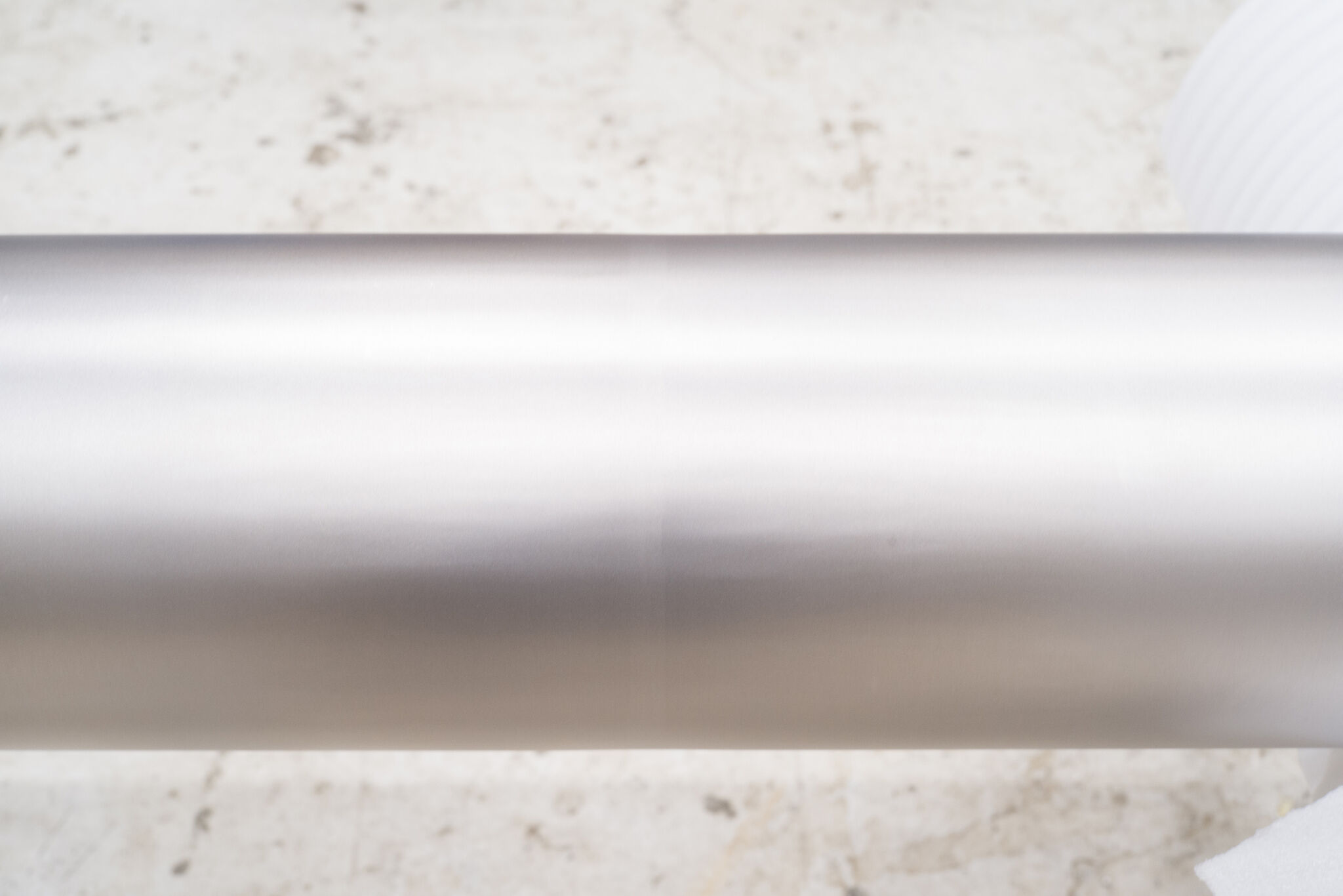 Close-up view of a shiny stainless steel pipe.