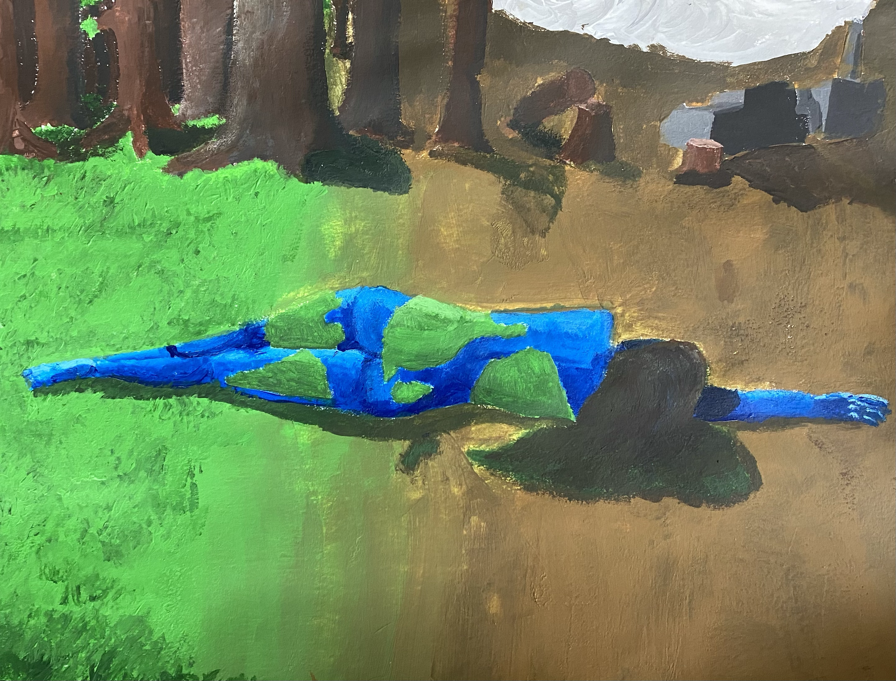 A woman, painted blue and green to evoke the Earth, is lying on the ground. 