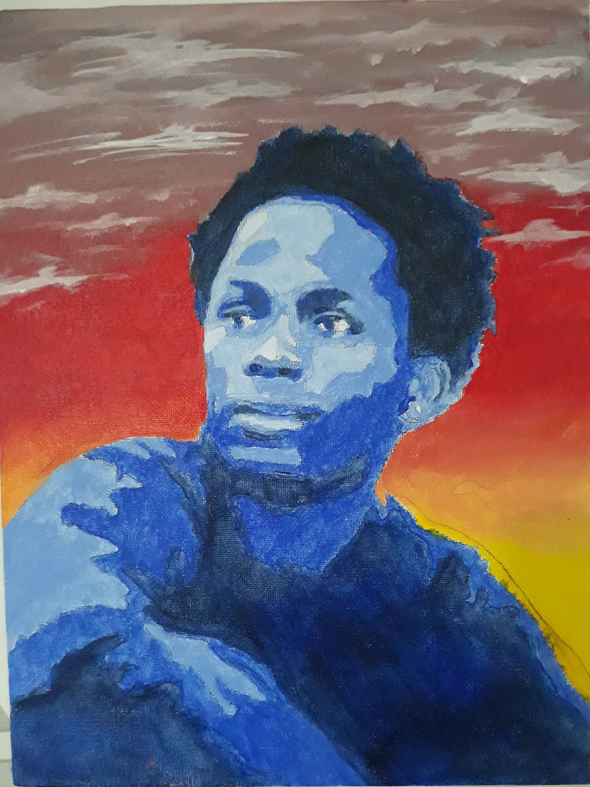 A portrait of Ishmael Beah against an orange and yellow background. 