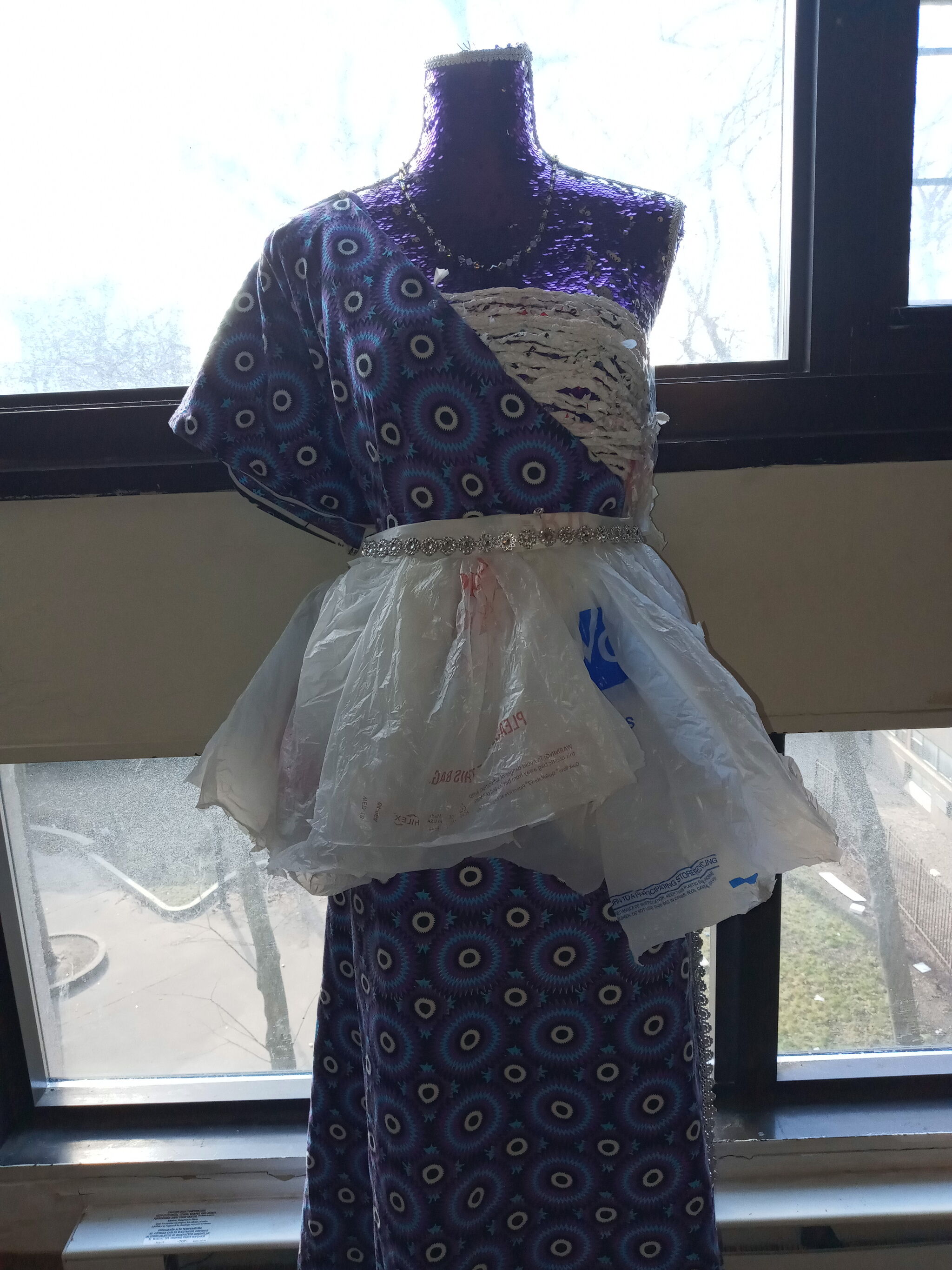 A mannequin with a dress made of ankara and plastic bags. 