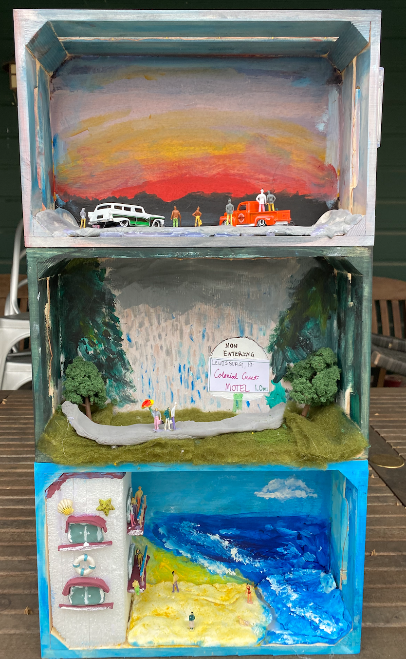 A series of three wooden clementine boxes stacked on top of each other, each depicting a different outside scene.