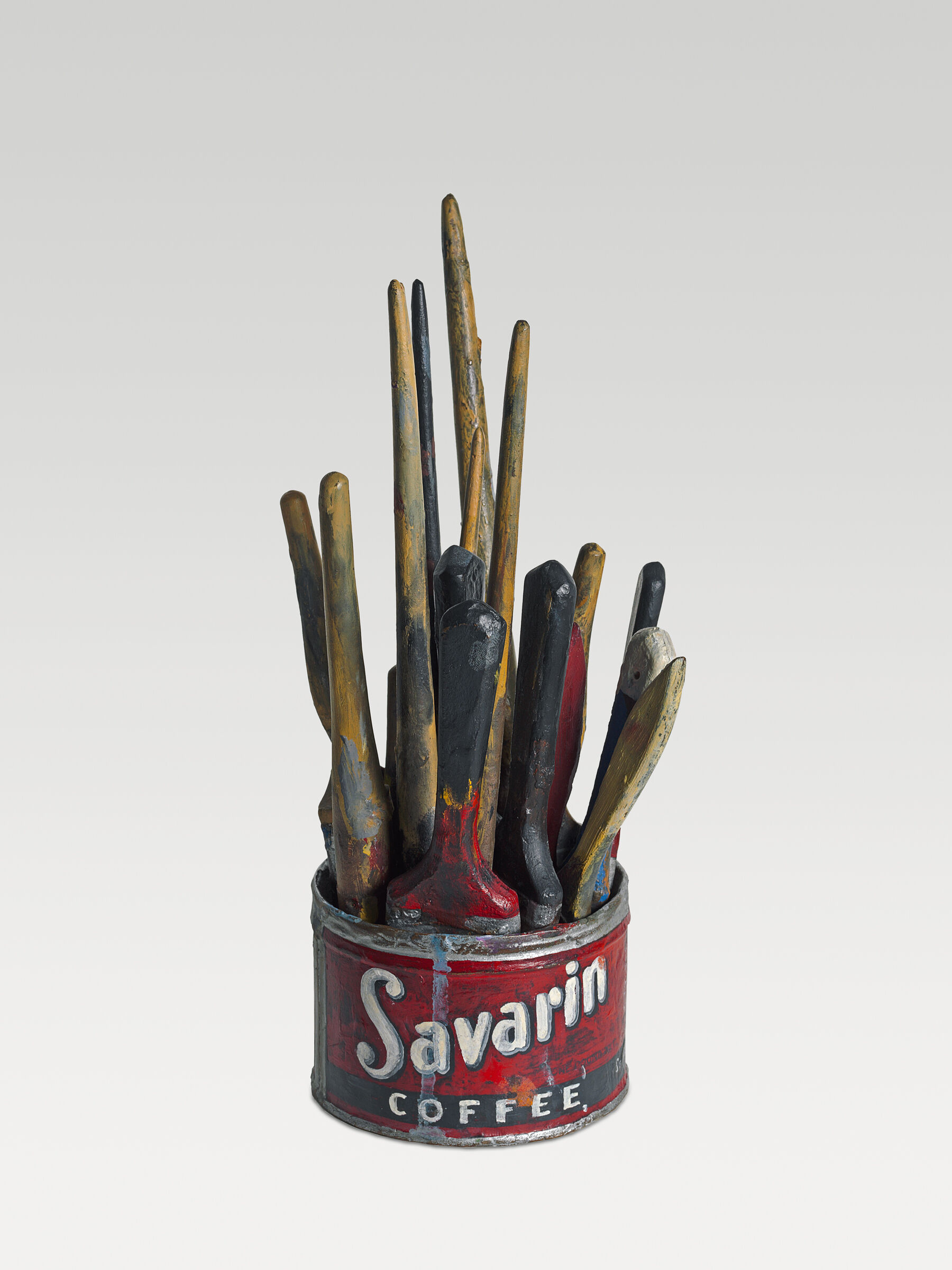 Sculpture of a red can of Savarin coffee filled with paintbrushes, their handles all sticking up and spattered with paint.