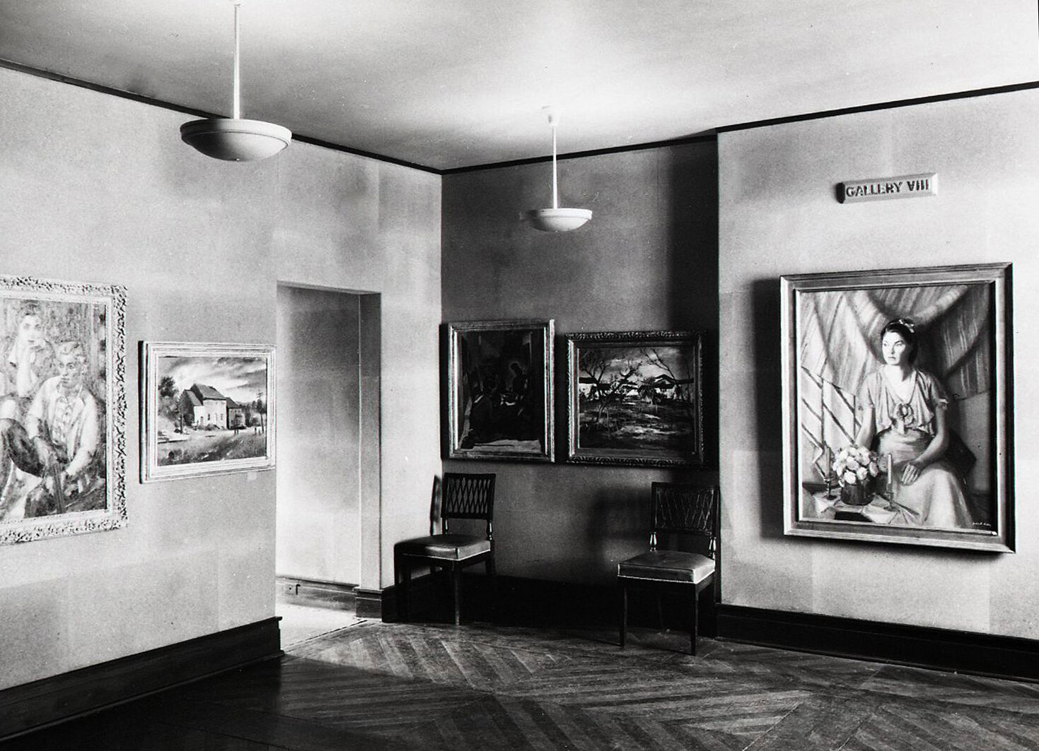 Black-and-white photographs of paintings hanging in a gallery.