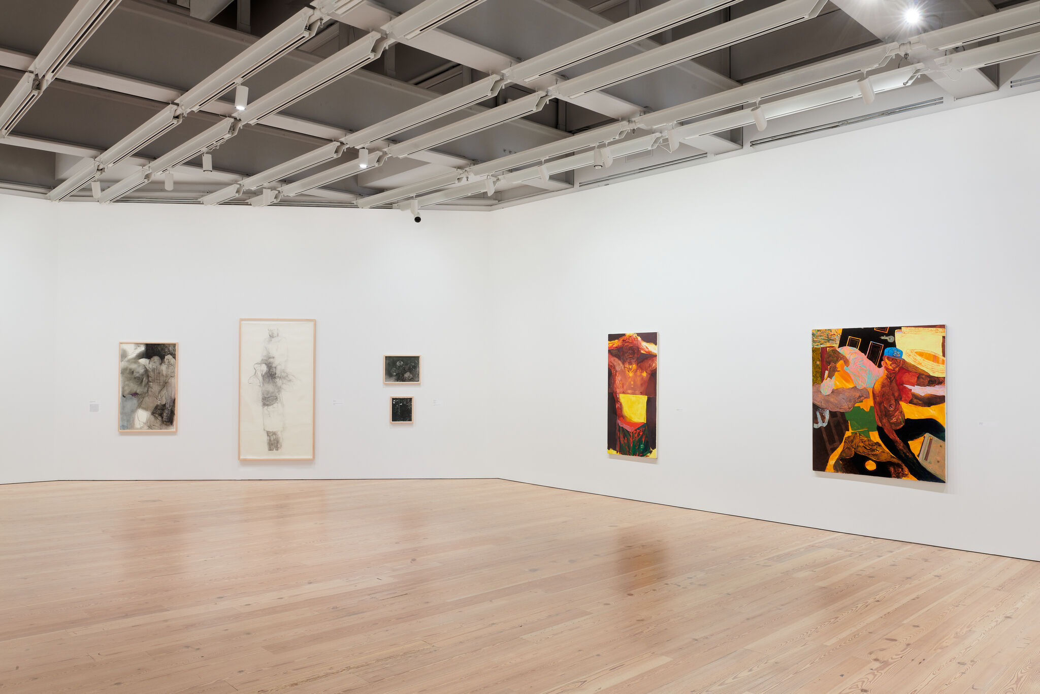 A white exhibition wall with six works mounted next to each other. 