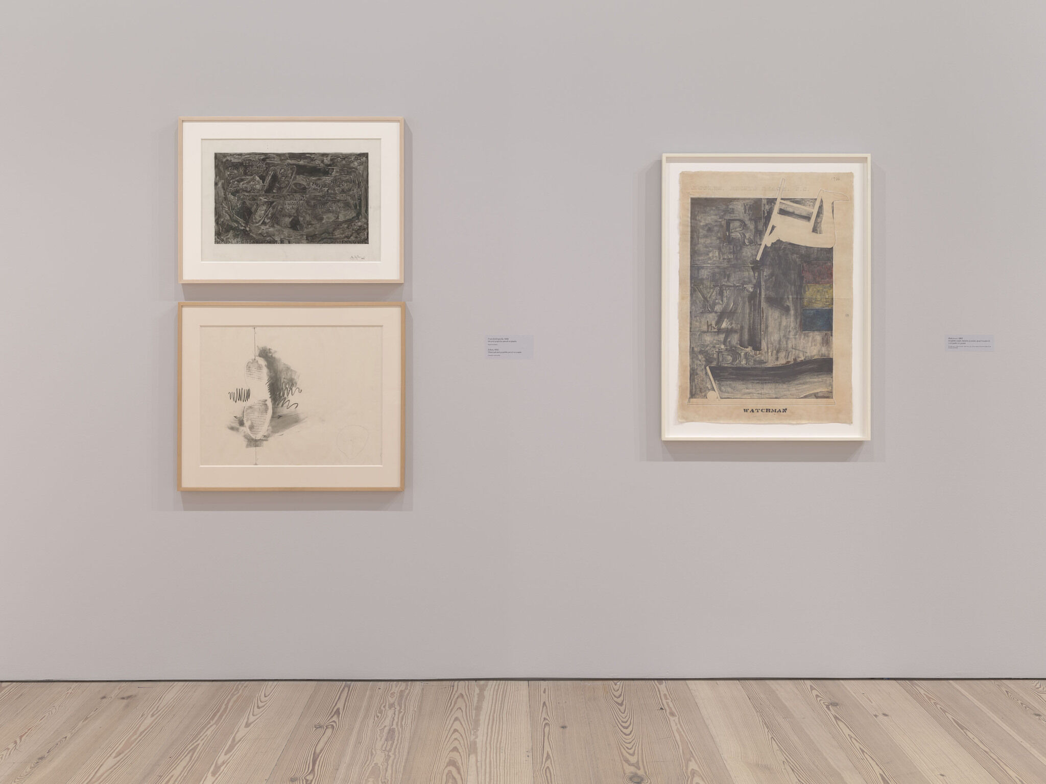 A white exhibition wall with three framed works mounted next to each other. 
