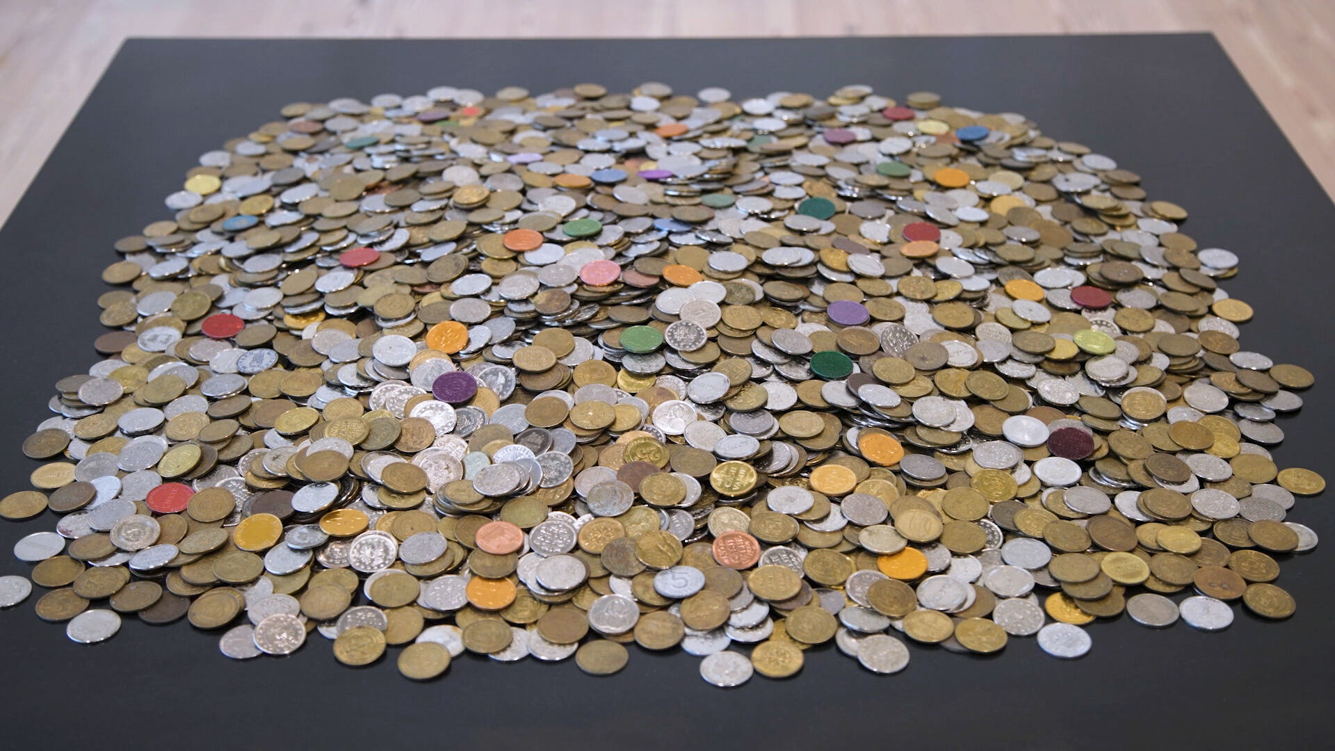 Many different kinds of coins and small, flat, round-shaped objects.