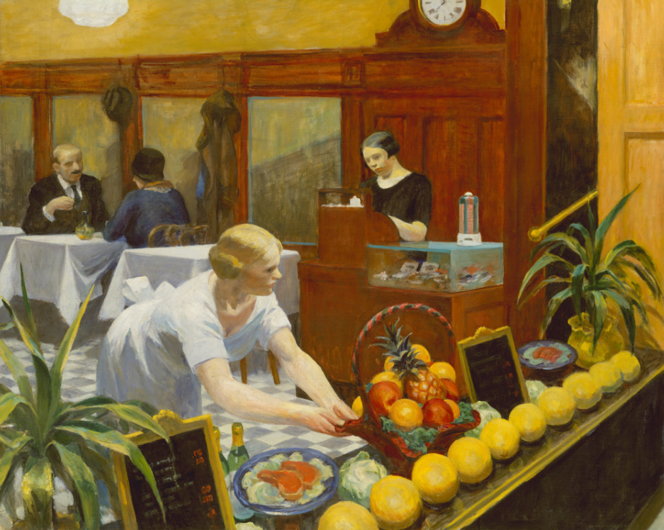 A woman places a fruit basket on a table in a busy restaurant.