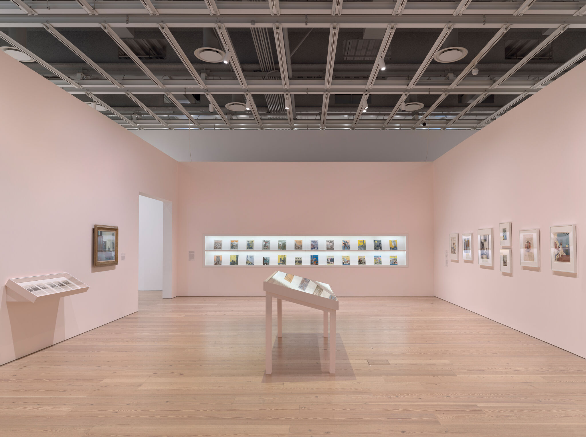 Multiple artworks in a pink gallery.