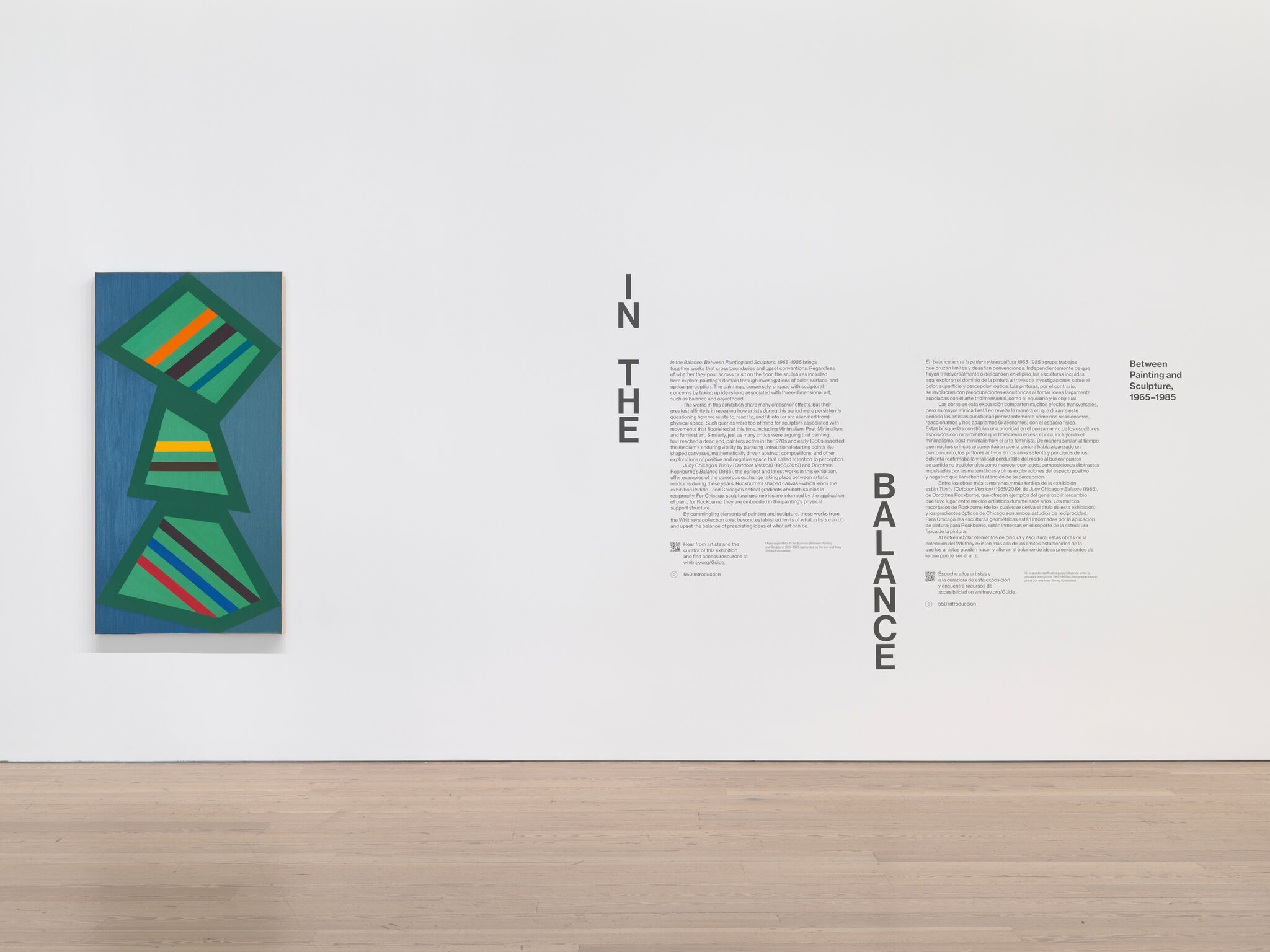 Artwork and text in a light-filled gallery.