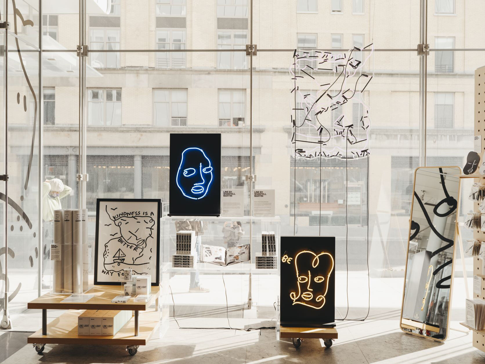 Whitney Shop windows featuring Shantell Martin line art faces and text clip products.