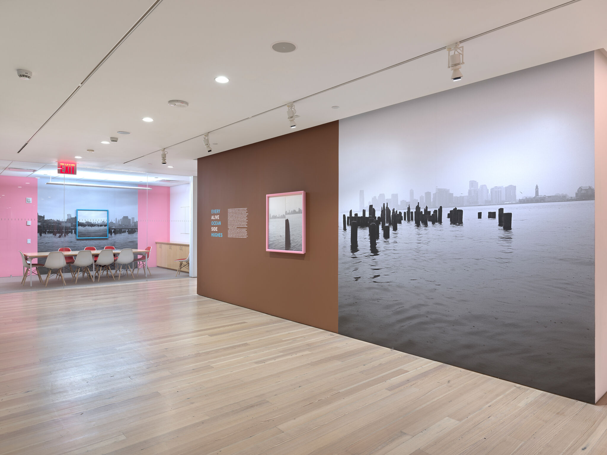 Multiple artworks in a brown and pink gallery.