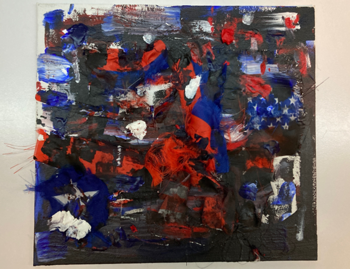Abstract piece incorporating torn up pieces of the American flag.