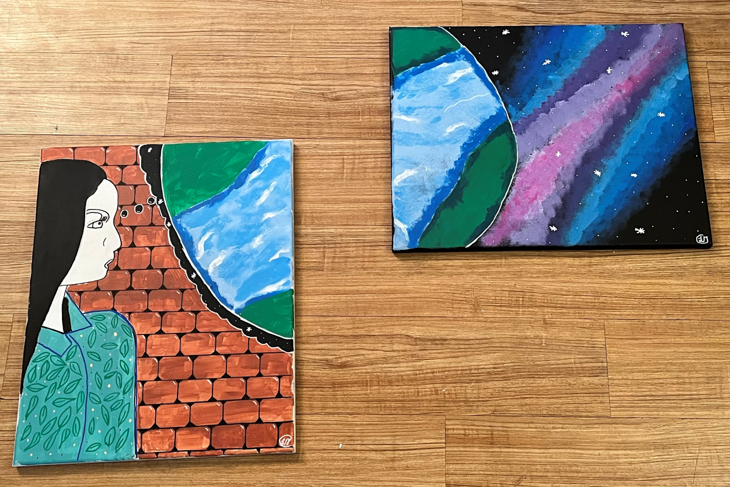Two drawings, one depicting a woman sideways against a backdrop of bricks and the other showing a planet in a galaxy.