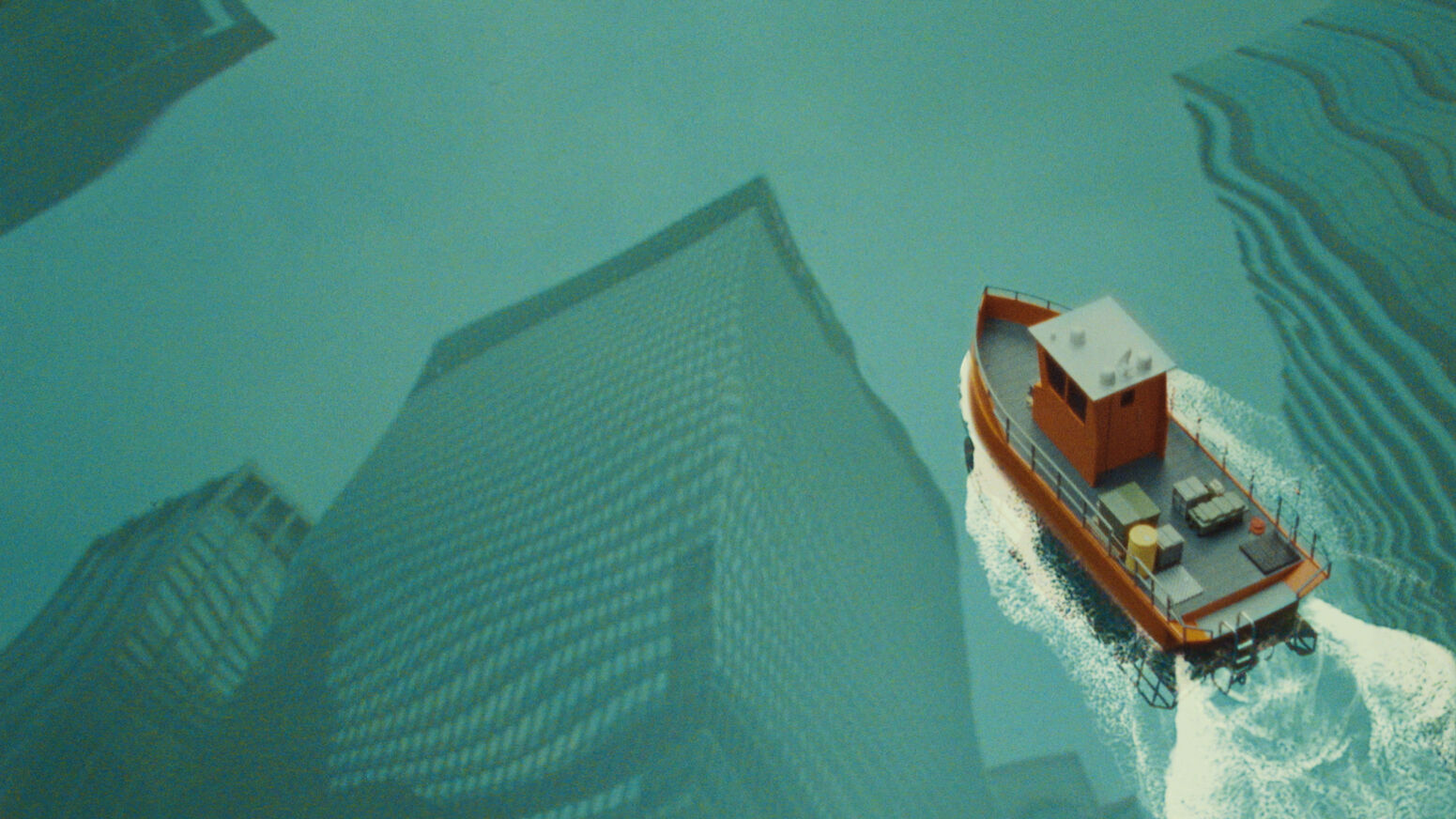 A boat floating on water reflecting a cityscape above. 