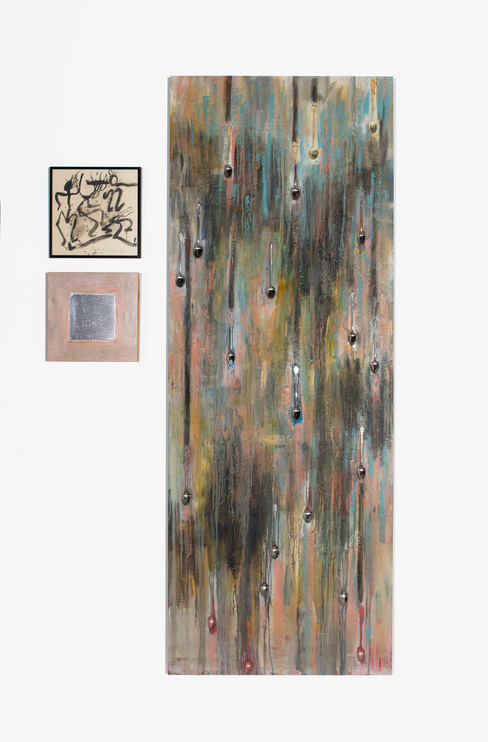 Drips in black glisten and gleam and appear to roll down a backdrop of pastels. 