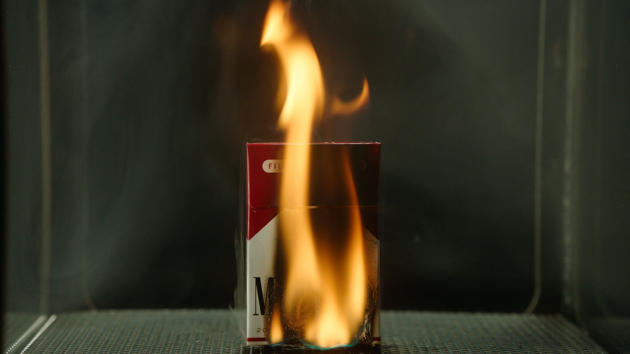 A Marlboro pack of cigarettes on fire 