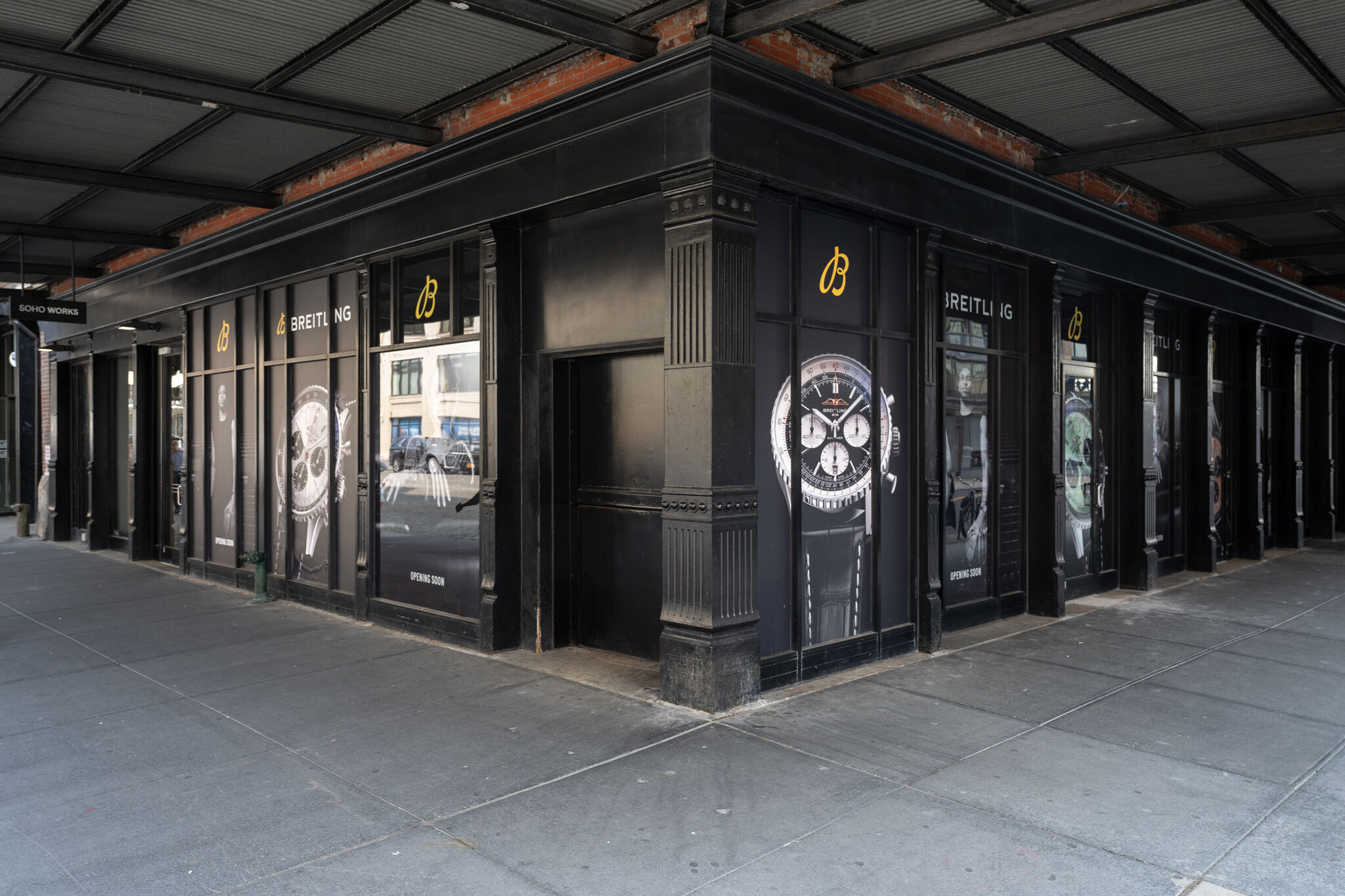 The corner of a large black building facade. 