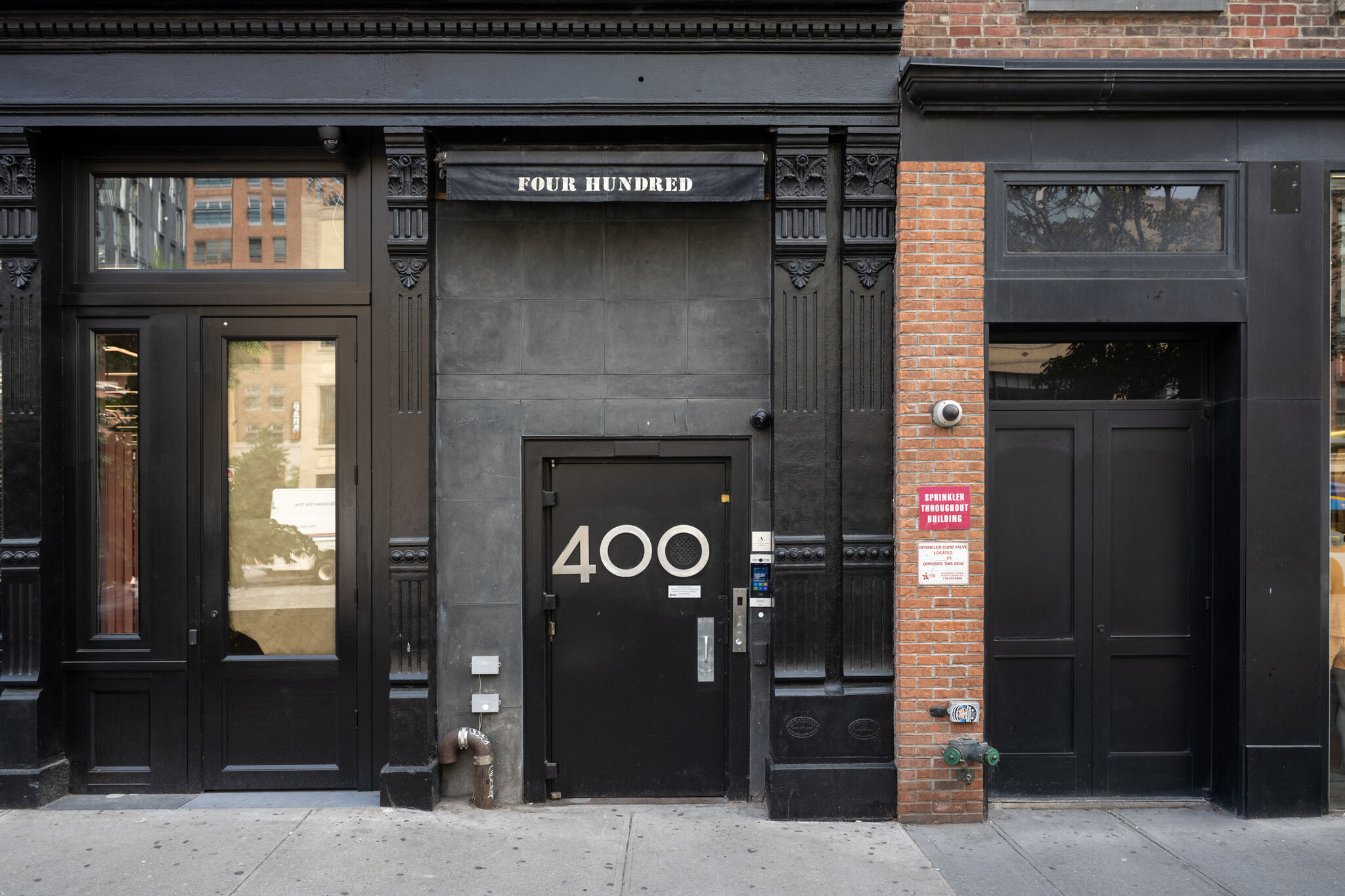 The facade of a stone building painted black.