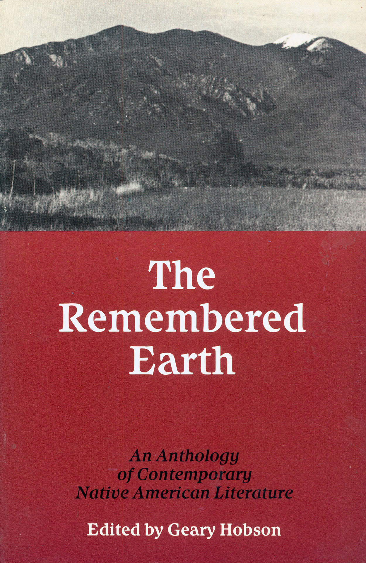 A book cover showing mountains and text on a red background. 