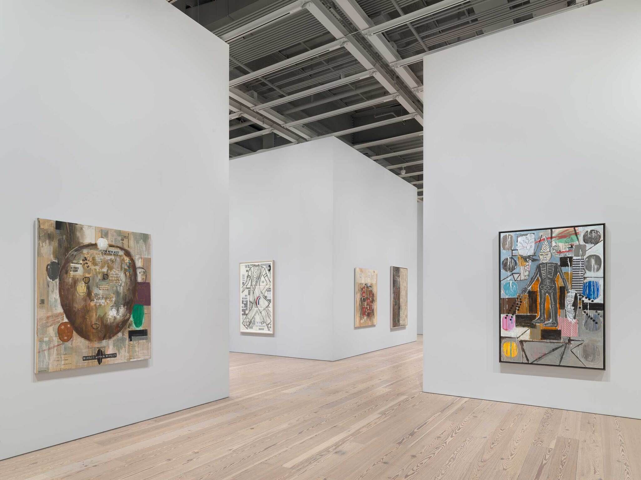 In the background, three beige colored paintings on different walls, and in the foreground on the left, a circular brown painting and on the right a figure with a skeleton surrounded by abstract shapes.