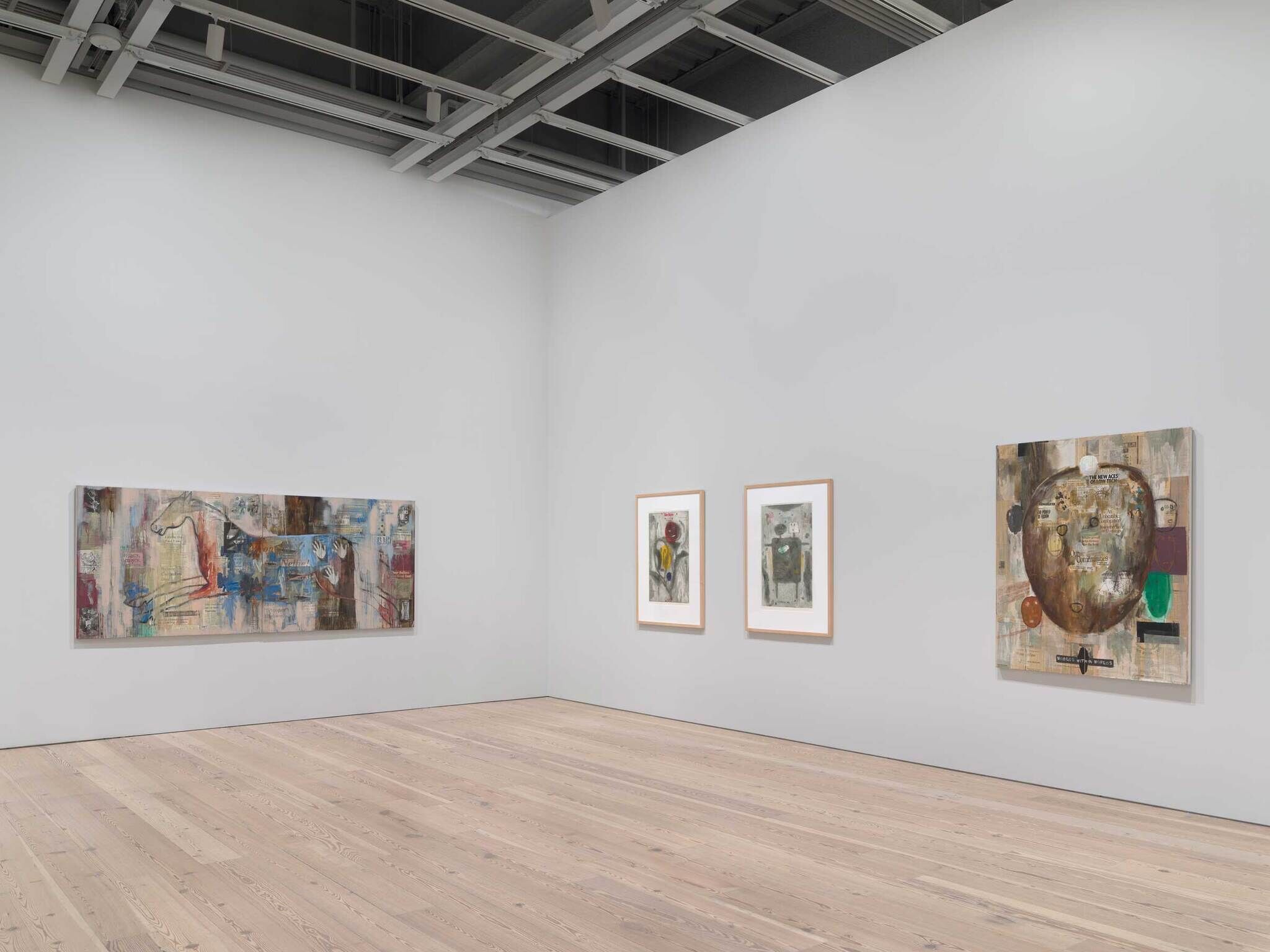 From left to right: a landscape painting with a horse lying down, two gray abstract paintings with wooden frames, and a painting with a circle and abstract shapes inside.
