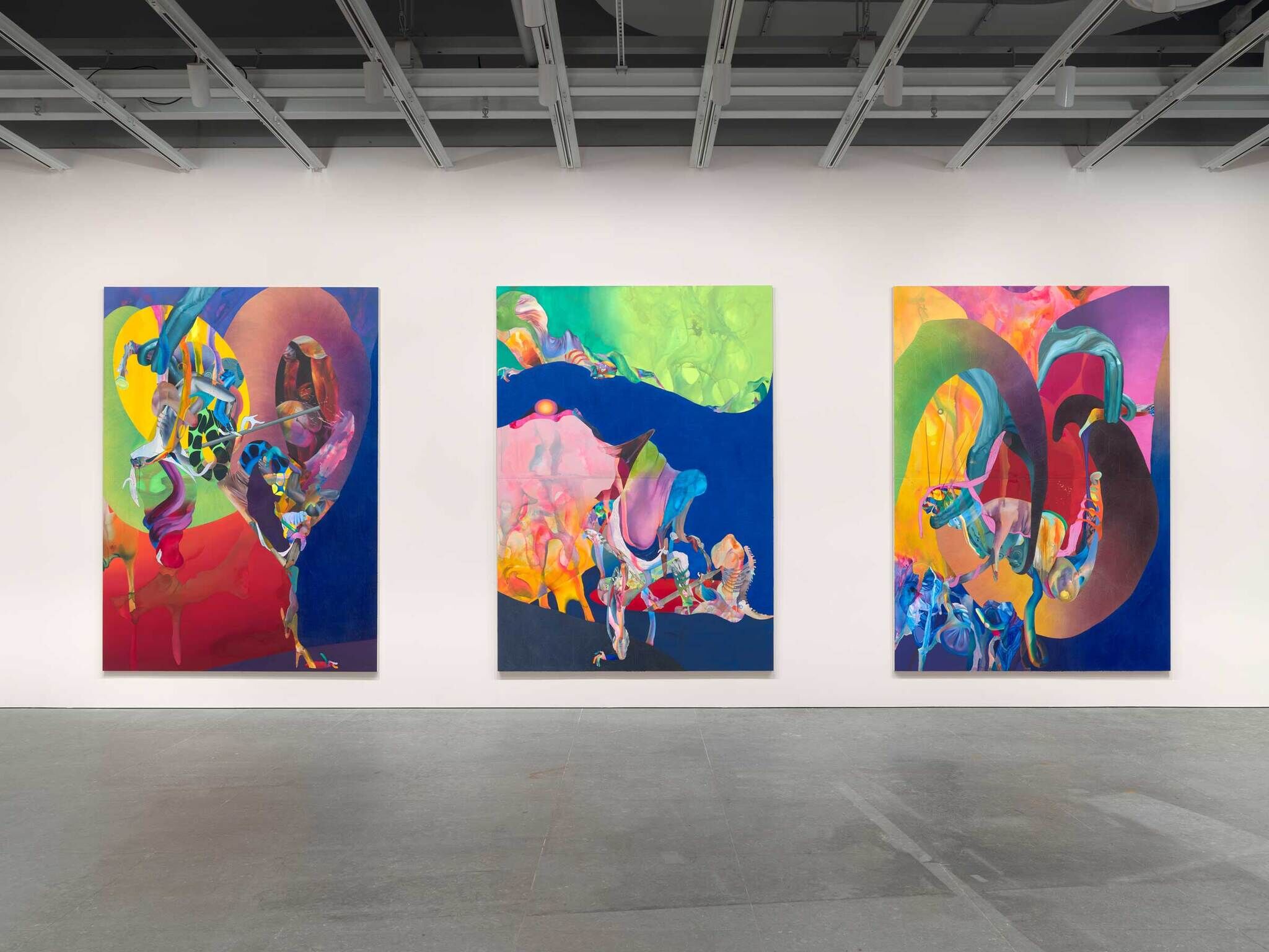 An installation view of three vivid, bright, and abstract paintings.