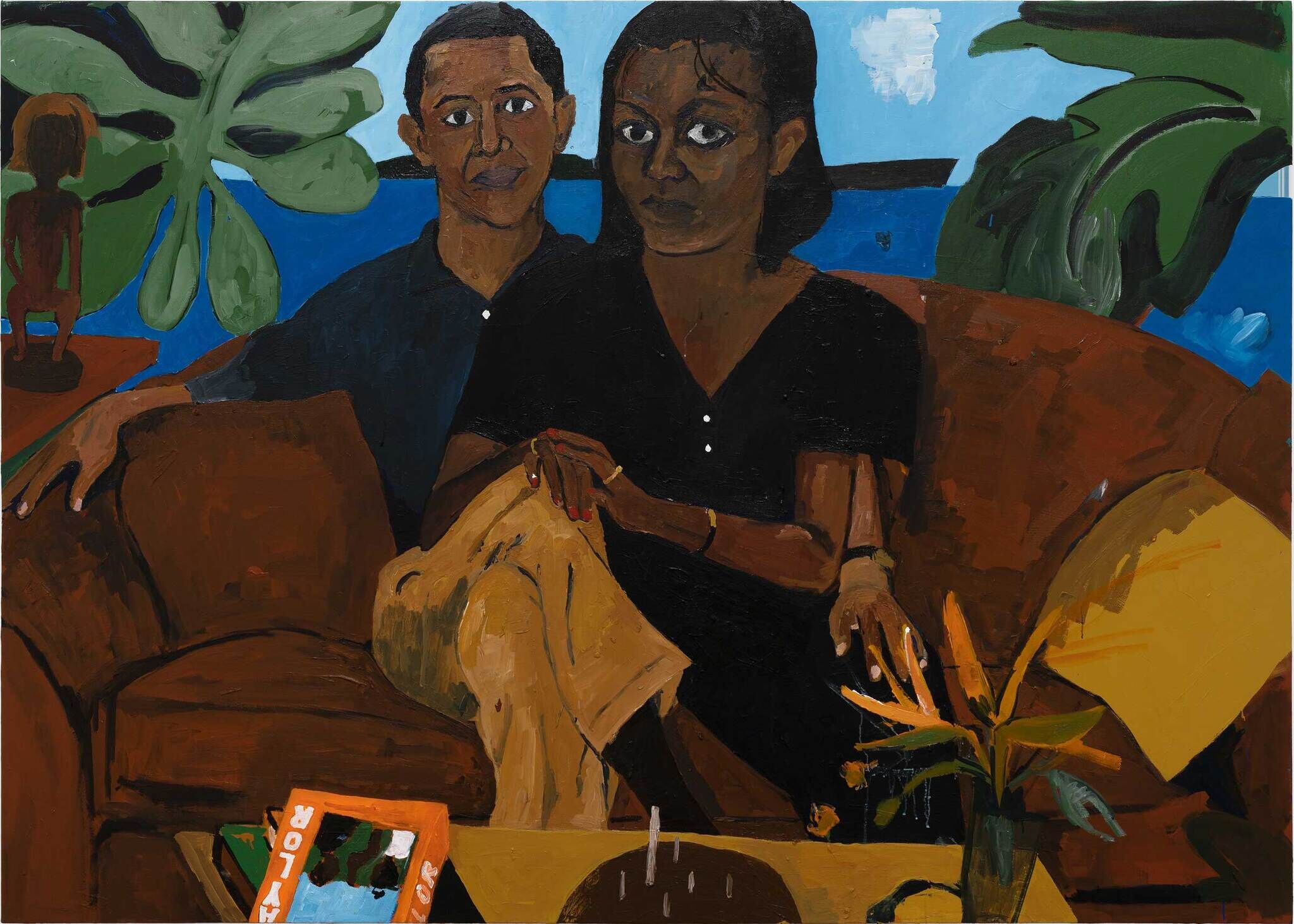 A close up portrait of a couple, man and woman, sitting on a brown sofa against a blue background and green plant leaves.