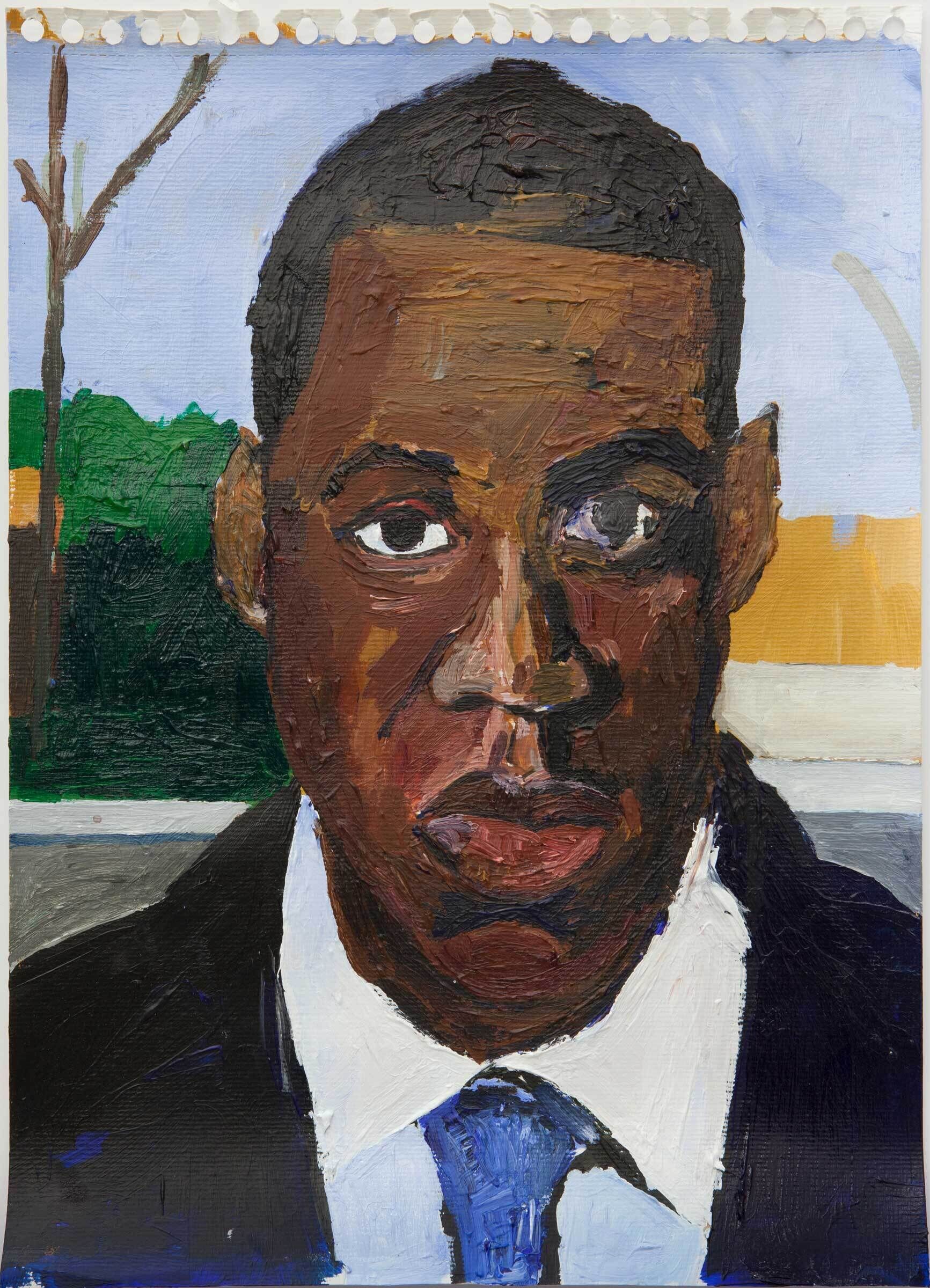 A closeup portrait of a Black man in a suit and tie. He appears to be standing in front of a neighborhood street, as a road, sidewalk, bushes, and a wooden fence are visible in the background.