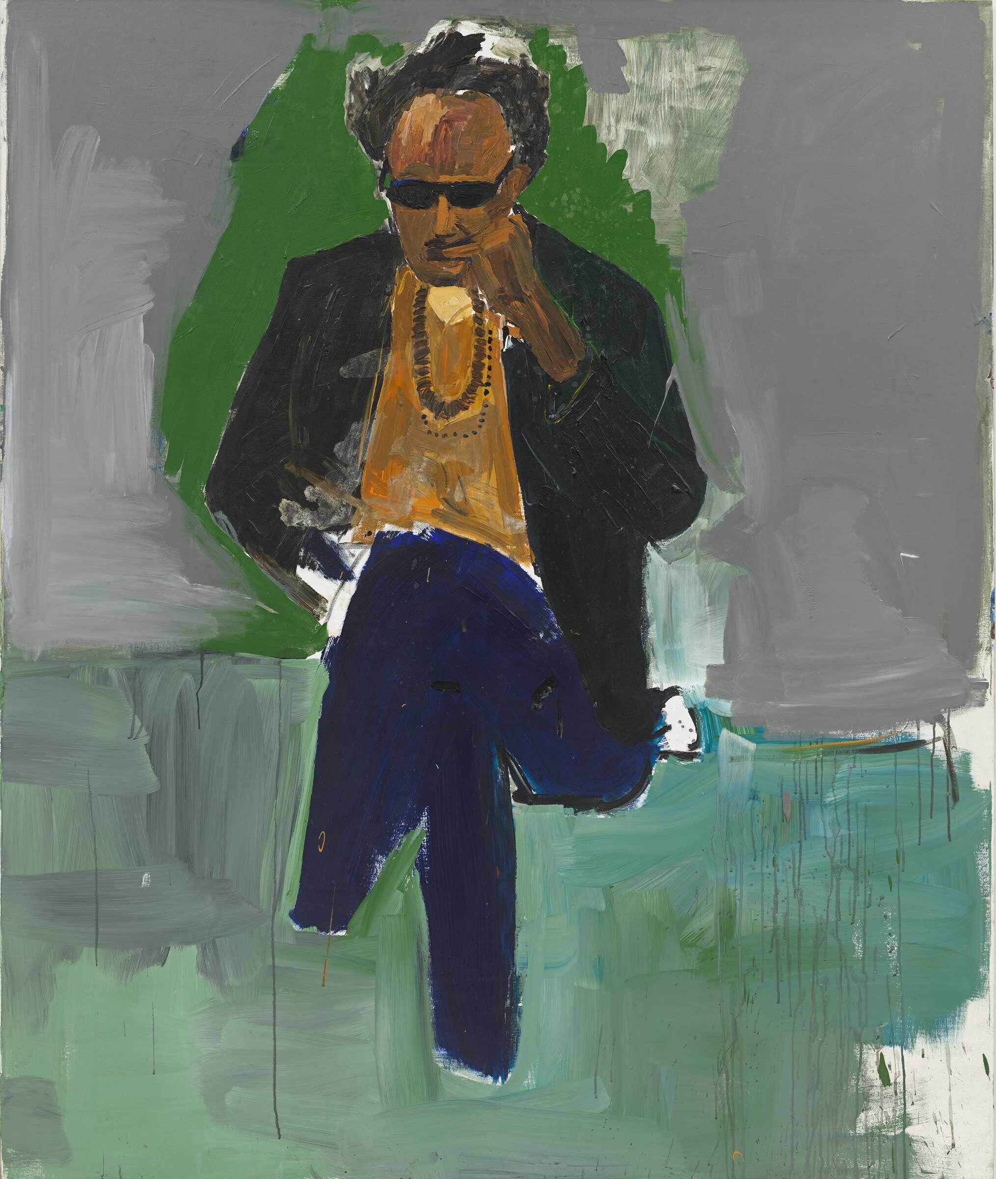 Steve Cannon, a Black man, sits with his legs crossed. He is wearing a mustard colored shirt, a black jacket, jeans, sunglasses, and a brown necklace. The background is grey and green.