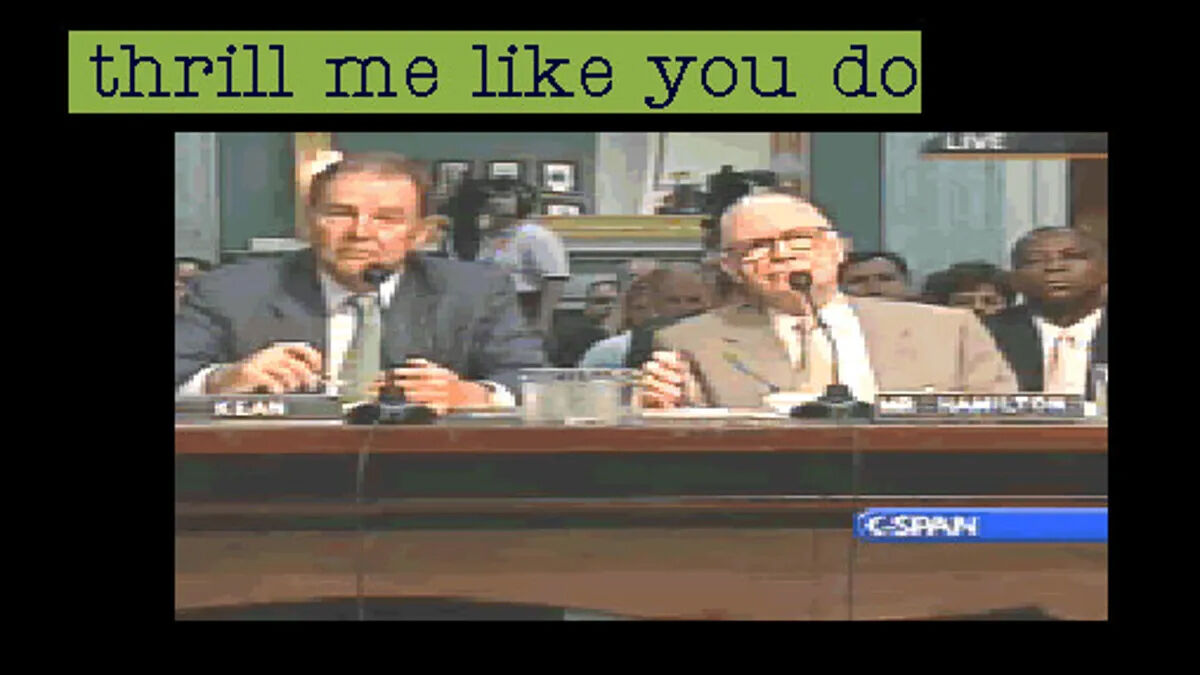 Two men at a desk on a C-SPAN feed wearing suits with a big text bubble over their heads that says "thrill me like you do".
