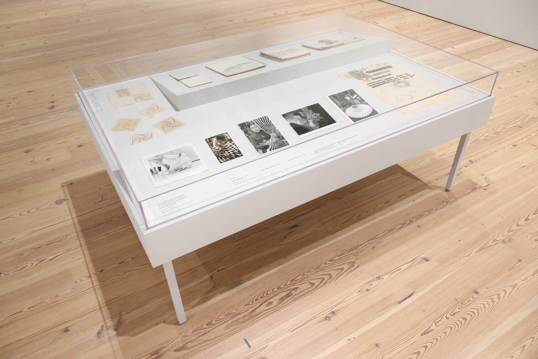 Prints and drawings in a glass case.